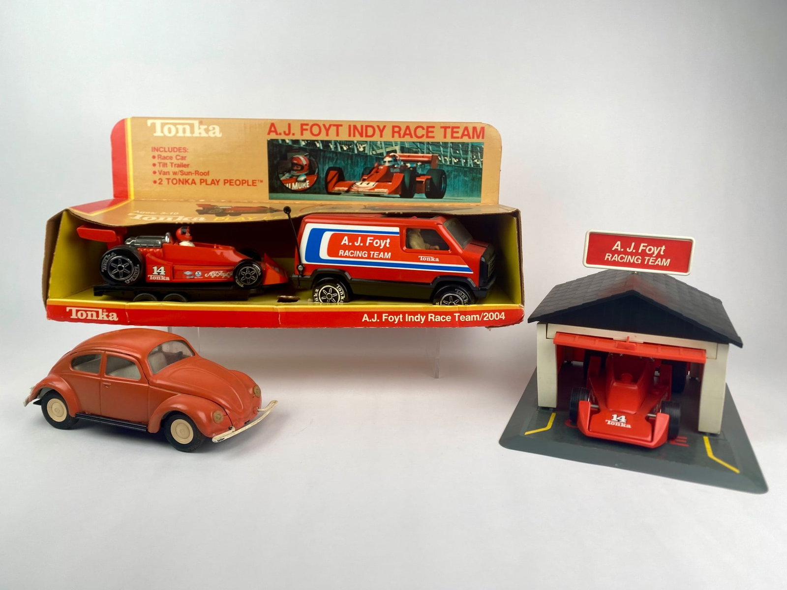 Tonka A.J. Foyt Indy Race Team Set with Garage and Volkswagen Beetle: Vintage A.J. Foyt Indy Race Team collection, including multiple playsets and vehicles. Featured is the boxed Tonka A.J. Foyt Indy Race Team set, which include the #14 Indy race car, racing team van wi