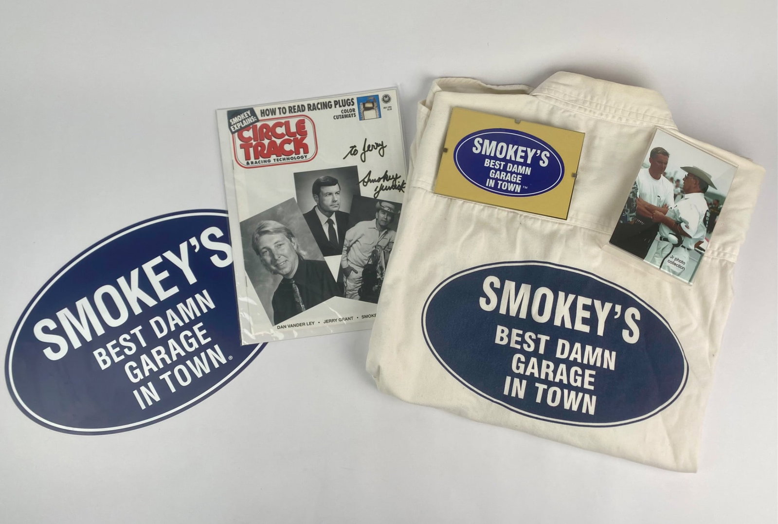 Smokey Yunick 'Best Damn Garage in Town' Memorabilia Set with Signed Magazine: Smokey Yunick memorabilia set centered around his iconic "Best Damn Garage in Town" branding. The lot includes a short-sleeve button up shirt with "Smokey's Daytona Beach, FL" on the front and "Smokey