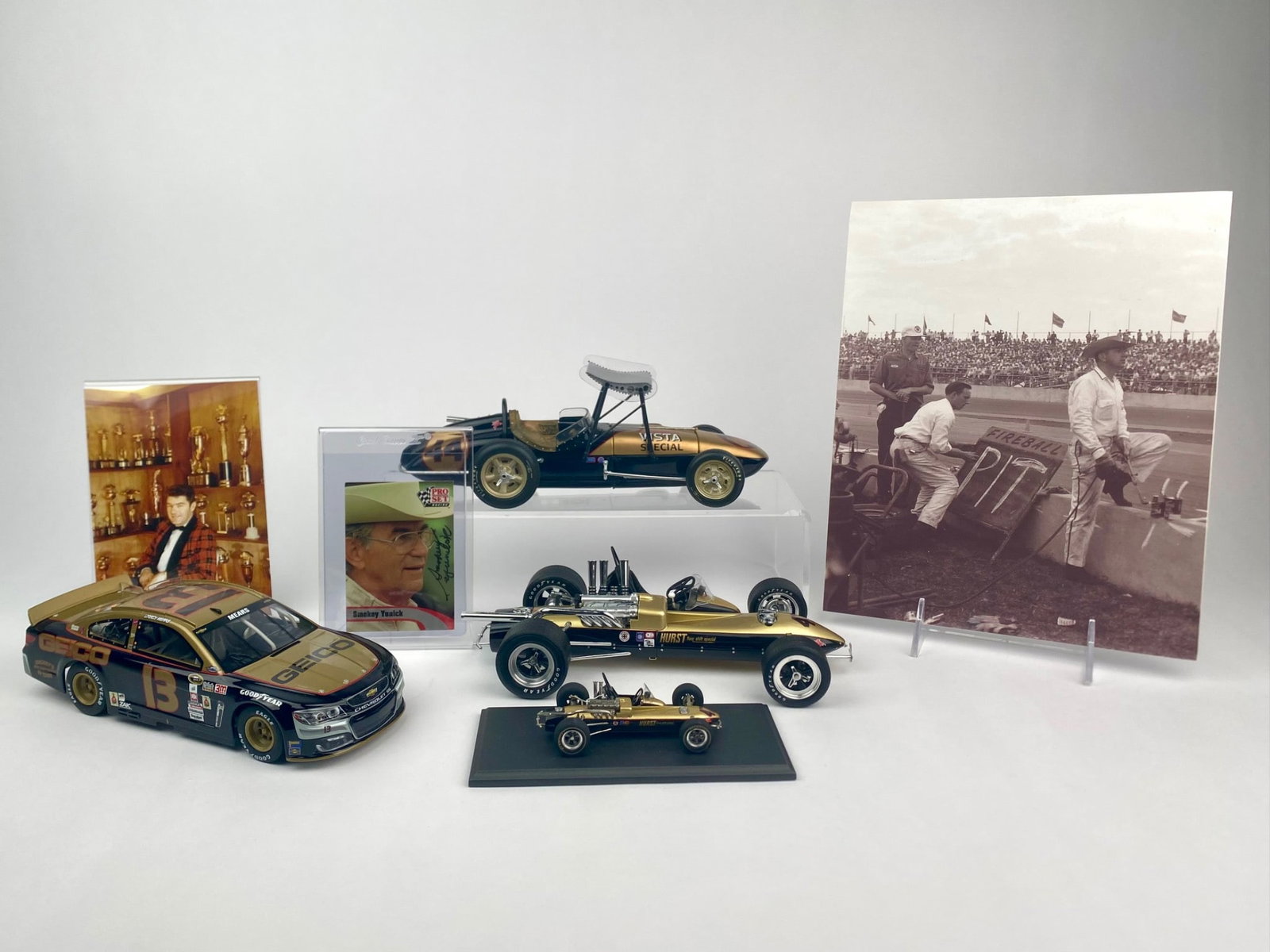 Smokey Yunick Tribute Racing Collection with Signed Card and Die-Cast Models with boxes and COA: Smokey Yunick tribute collection featuring multiple display pieces. The set includes a 1:24 scale Lionel die-cast GEICO #13 Chevrolet stock car in black and gold, marked "Smokey's Best Damn Garage in 