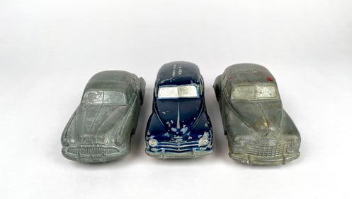 Three Vintage National Products Cast Aluminum Cars