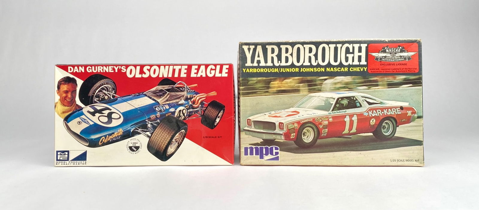 Two MPC Model Car Kits: Yarborough NASCAR Chevy and Olsonite Eagle: Two MPC model car kits included in this lot: Yarborough/Junior Johnson NASCAR Chevy, 1/25 scale, with parts and decals, showing wear on the box but containing assembly materials. Dan Gurney's Olsonite