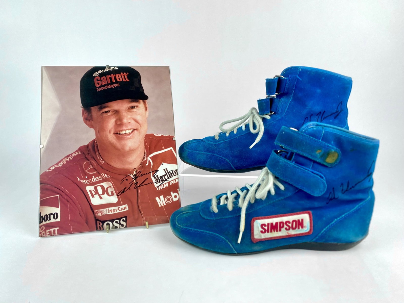 Al Unser Jr. "Little Al" Signed Simpson Racing Shoes and Autographed Portrait: Set features a pair of Simpson suede racing shoes signed on the sides by Al Unser Jr., also known as "Little Al." The shows show clear signs of use with wear and aging to the suede and soles. Included
