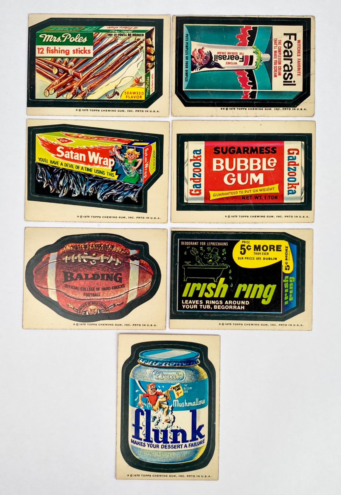 7 1975 Topps Wacky Packages Die-Cut Stickers: 7 1975 Topps Wacky Packages die-cut stickers featuring original humor-inspired parodies: "Mrs. Poles 12 Fishing Sticks," "Fearasil," "Satan Wrap," "Sugarmess Bubble Gum," "Irish Ring," "Baldding Footb