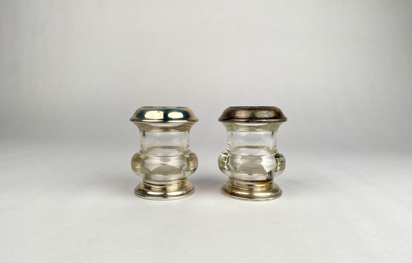 Pair of Frank M. Whiting Sterling-Mounted Glass Toothpick Holders: Glass toothpick mounted with sterling silver rims and bases by Frank M. Whiting. Stamped “Frank M. Whiting Sterling Pat. Pending” on the rims and “Sterling” on the bases. Notable wear