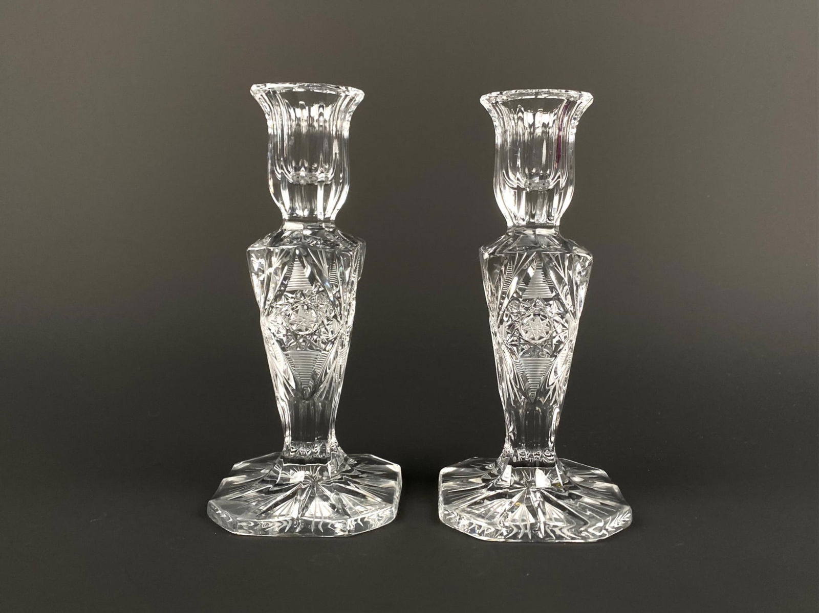 Pair of American Brilliant Hand-Cut Crystal Candlesticks: Pair of American Brilliant Period hand-cut crystal candlesticks, each featuring a faceted base, flared rim, and deeply cut geometric motifs including hobstars, cross-hatching, and fan patterns. Pair i