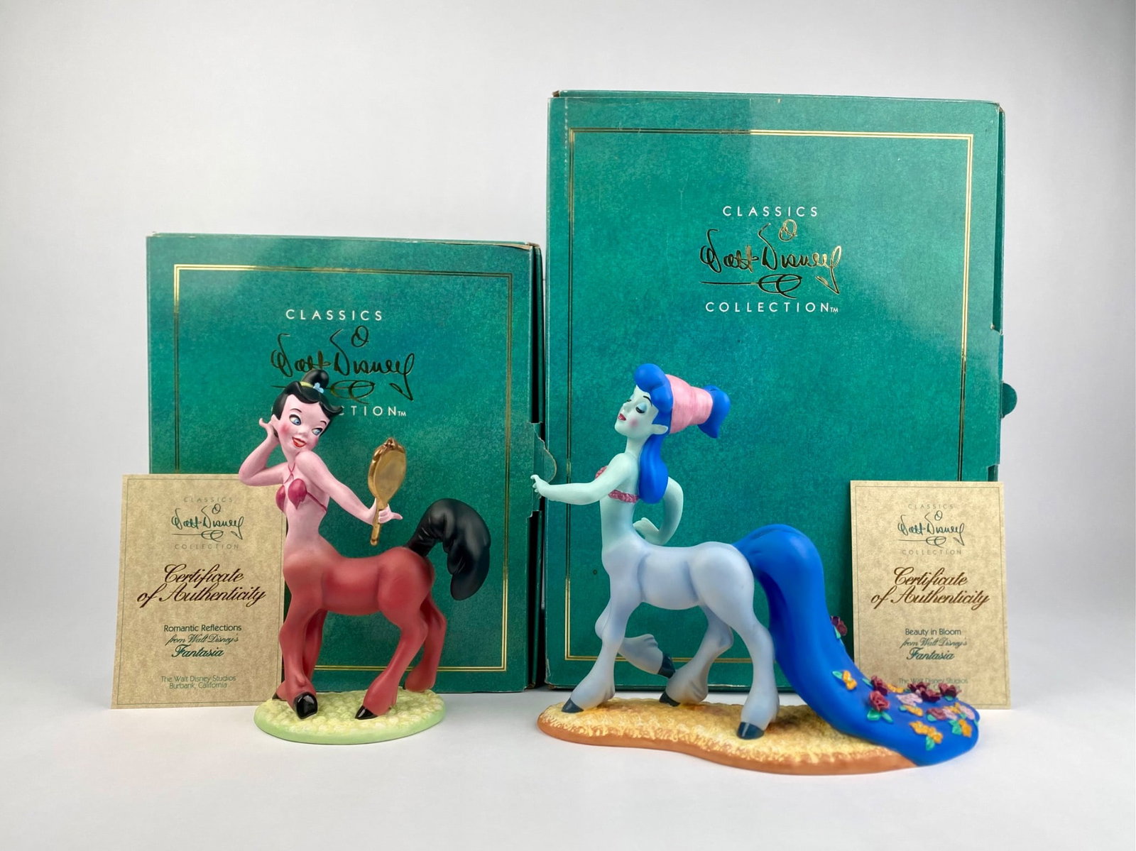 Pair of Disney Classics Collection 'Romantic Reflections' & 'Beauty in Bloom' Fantasia Figurines: Pair of Walt Disney Classics Collection figurines titled "Romantic Reflections" and "Beauty in Bloom" depicting the pink and blue centaurettes from Disney's Fantasia. Both figurines are marked with th