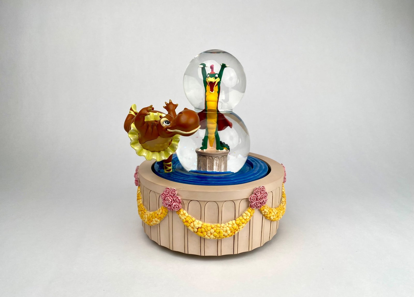 Disney Shopping 'Fantasia, Dance of the Hours' Double Snow Globe: Disney Shopping snow globe featuring a hippo and alligator scene, marked Item #99626. Manufactured in China for Disney Shopping Inc., Glendale, CA. Detailed sculpture with floral accents on the base. 