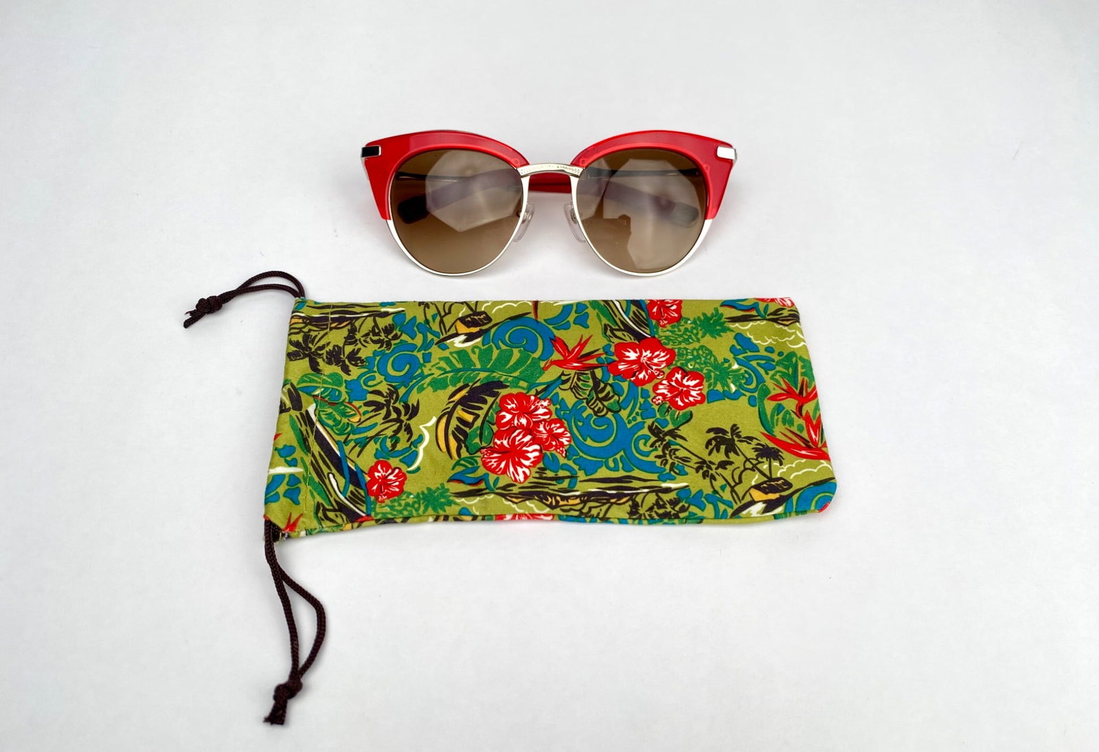 Paradis by Larry Sands “Stardust" Red and Silver Sunglasses: “Stardust” red and silver sunglasses. Includes tinted brown gradient lenses, adjustable nose pads, and embellished temple arms. Accompanied by an original floral soft case with a drawstring cl