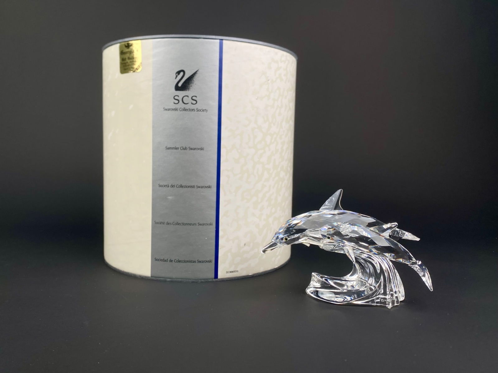 Swarovski SCS 1990 Annual Edition ‘Lead Me’ – The Dolphins with Original Box: Swarovski Crystal Society (SCS) Annual Edition for 1990 titled "Lead Me" The Dolphins, featuring two clear faceted crystal dolphins riding a cresting wave. Designed exclusively for the SCS members and