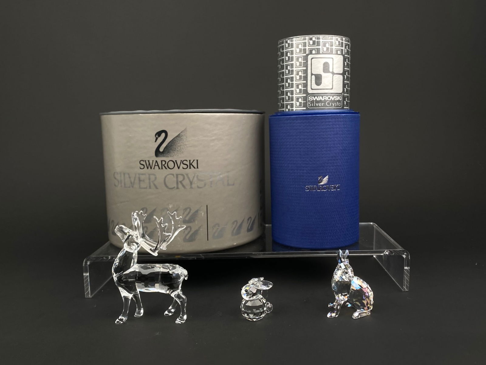 Swarovski Crystal Animal Trio – Reindeer, Arctic Hare, and Bunny with Original Boxes: Set of three Swarovski Silver Crystal figurines featuring the Reindeer, Arctic Hare Event Piece from 2011, and Bunny. Each figurine is crafted from faceted clear crystal with black crystal eyes. The A