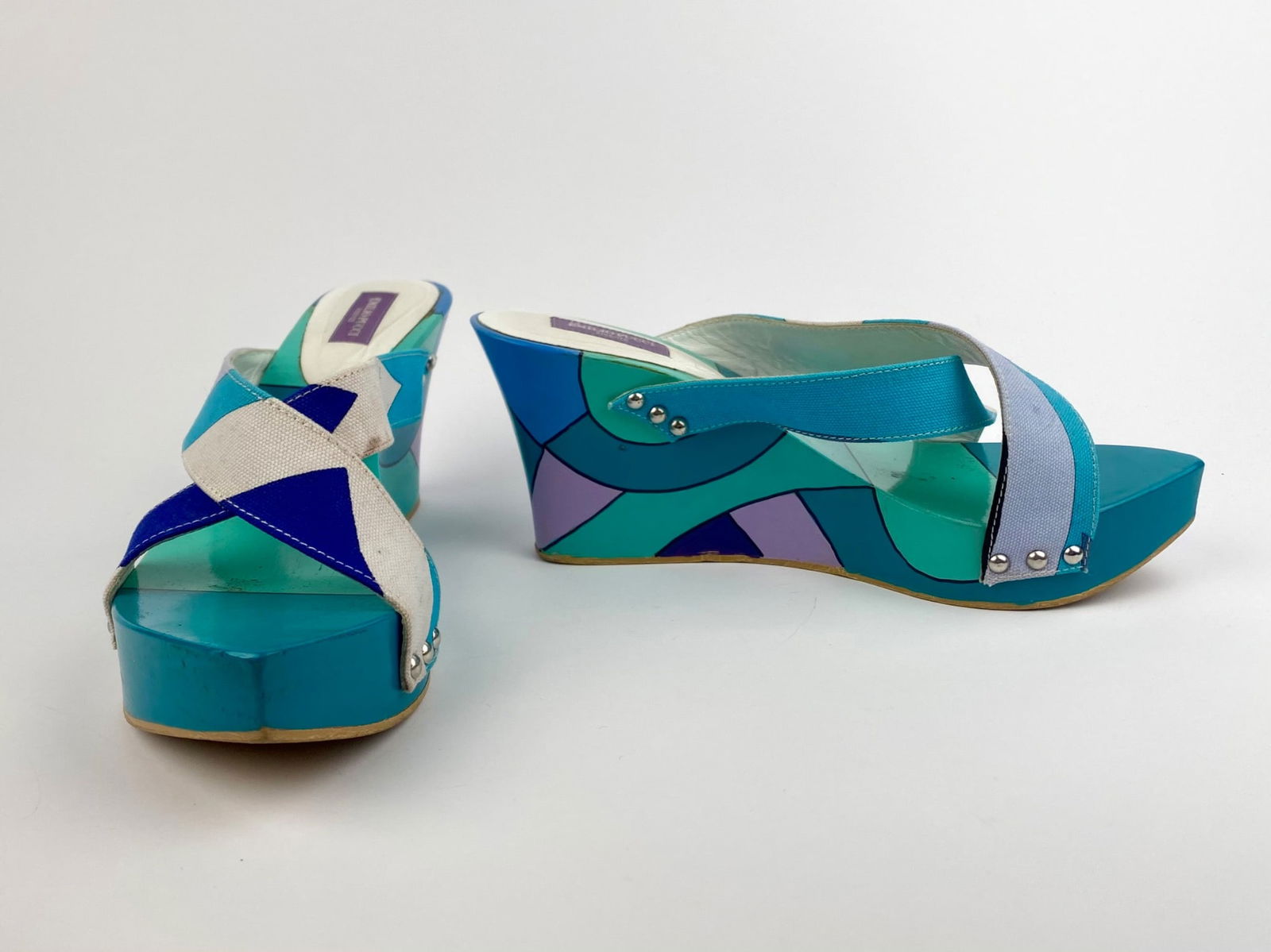 Emilio Pucci Firenze Multicolor Wedge Sandals, Size 38: Pair of Emilio Pucci Firenze wedge sandals featuring the brand’s signature geometric color-block design in shades of turquoise, aqua, blue, lavender, and cream. The shoes are constructed with crissc