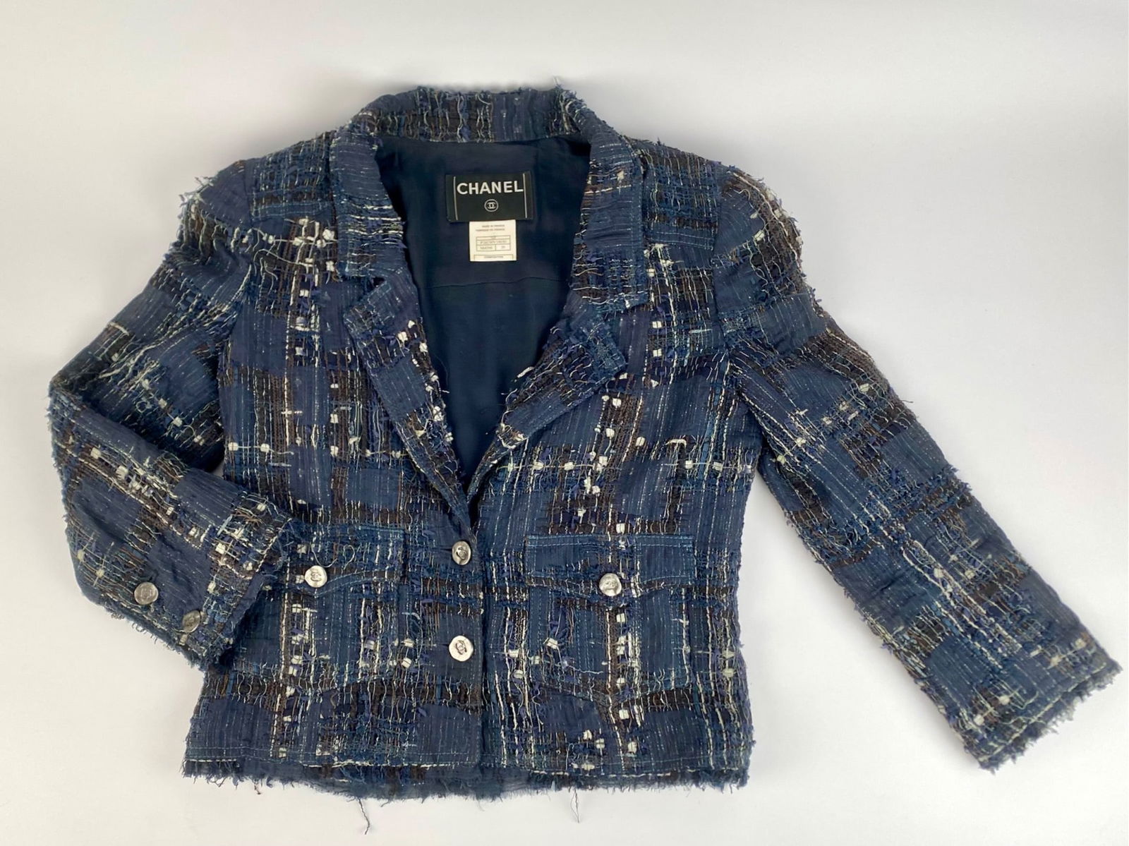 Chanel Metallic Tweed Cropped Jacket with Frayed Edges, Size 38: Chanel Spring 2006 cropped jacket in a blue, brown, ivory metallic tweed fabric, marked size 38 and made in France. The jacket is constructed from a blend of silk, polyamide, viscose, cotton, metal th