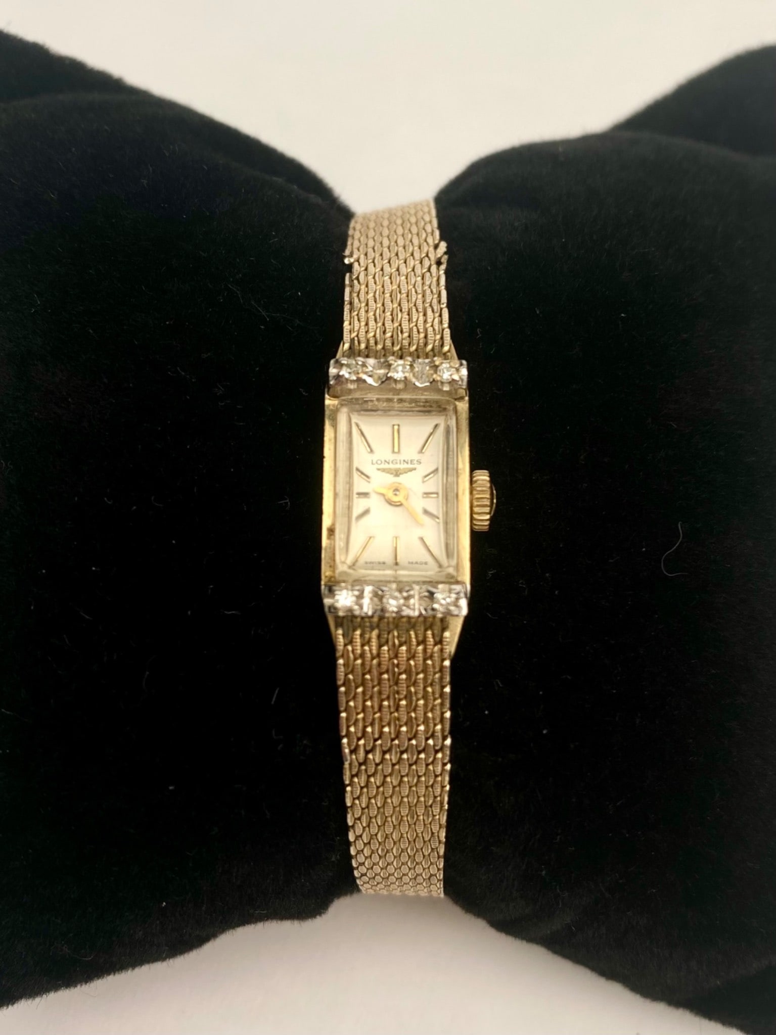 Longines Women 10K Rolled Gold Plate Watch with Diamond Accents: Longines women’s wristwatch featuring a 10K rolled gold plate bezel and band, with a stainless steel back. Marked Swiss Made on the dial, the watch showcases diamond accents on both the upper and lo