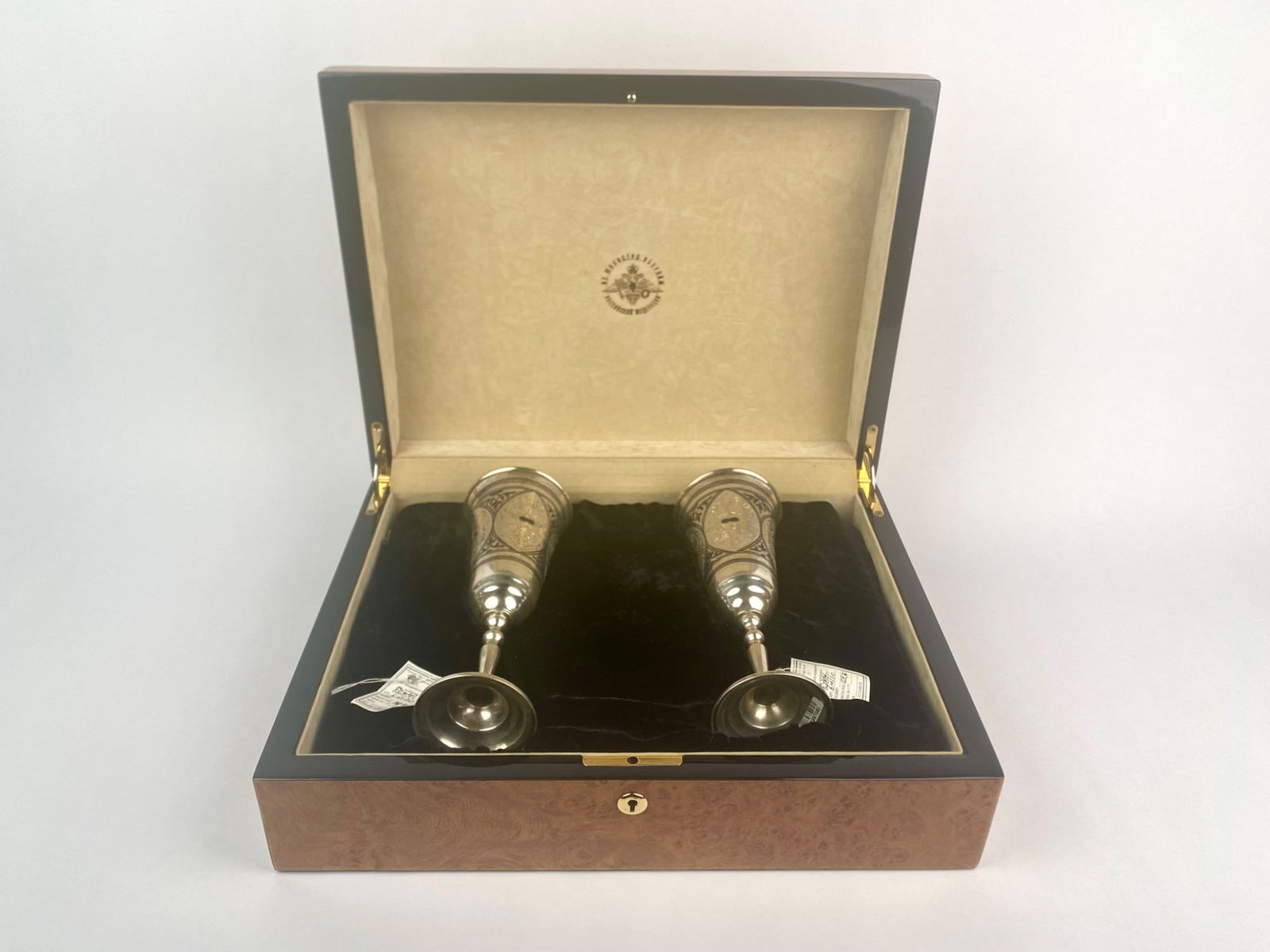 Pair of Russian Silver Goblets in Presentation Case: Pair of Russian silver goblets, each finely engraved with foliate and geometric designs accented in black niello. The goblets bear original factory tags from the Makhachkala Art Combine (Dagestan, Rus