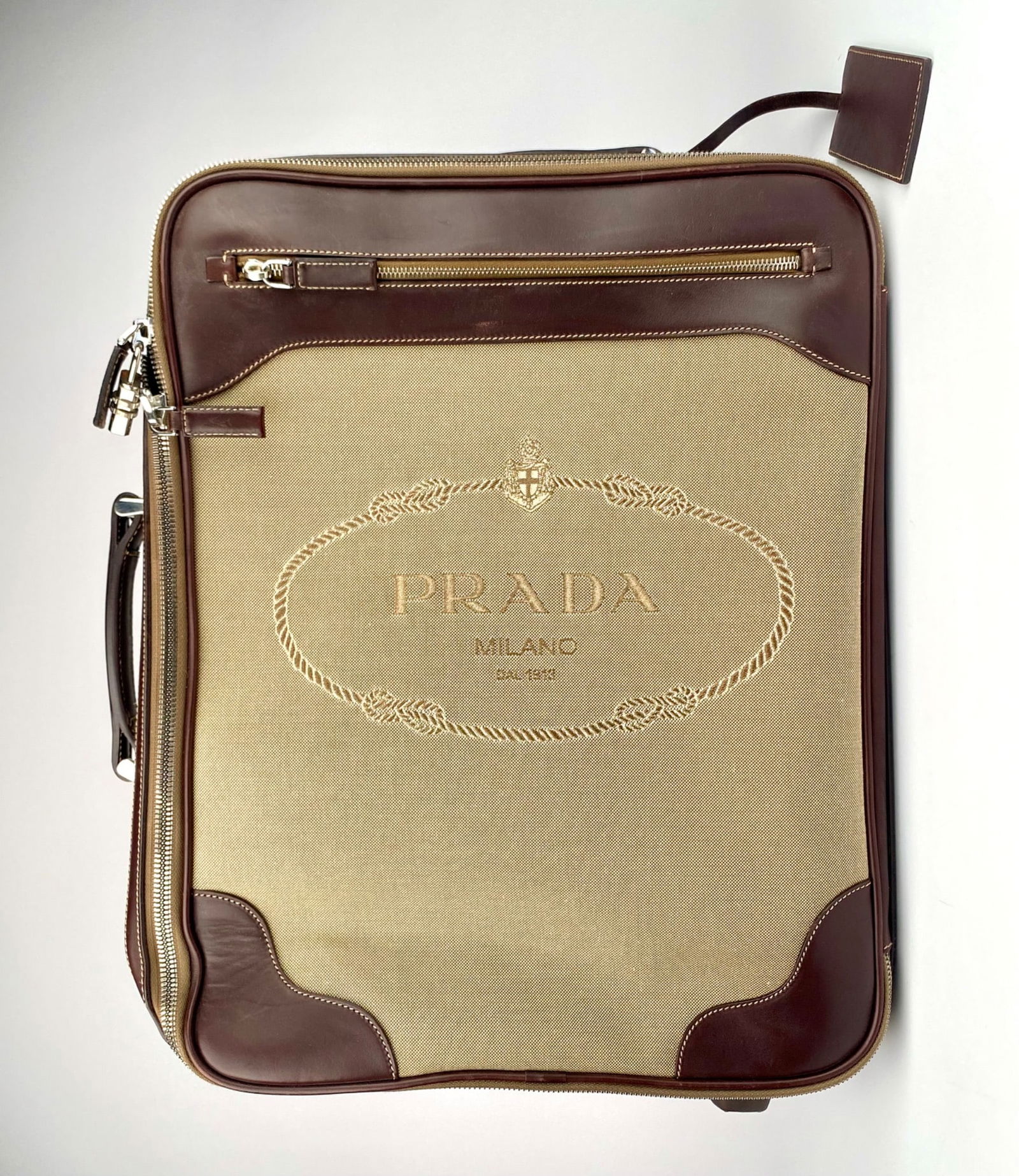 Prada VV030M Logo Jacquard Corda + Moro Rolling Suitcase with Leather Trim: Prada Milano jacquard fabric and leather luggage bag in corda and moro color combination. Features include a zip-around closure, top leather handle, retractable handle, two wheels, and protective hard