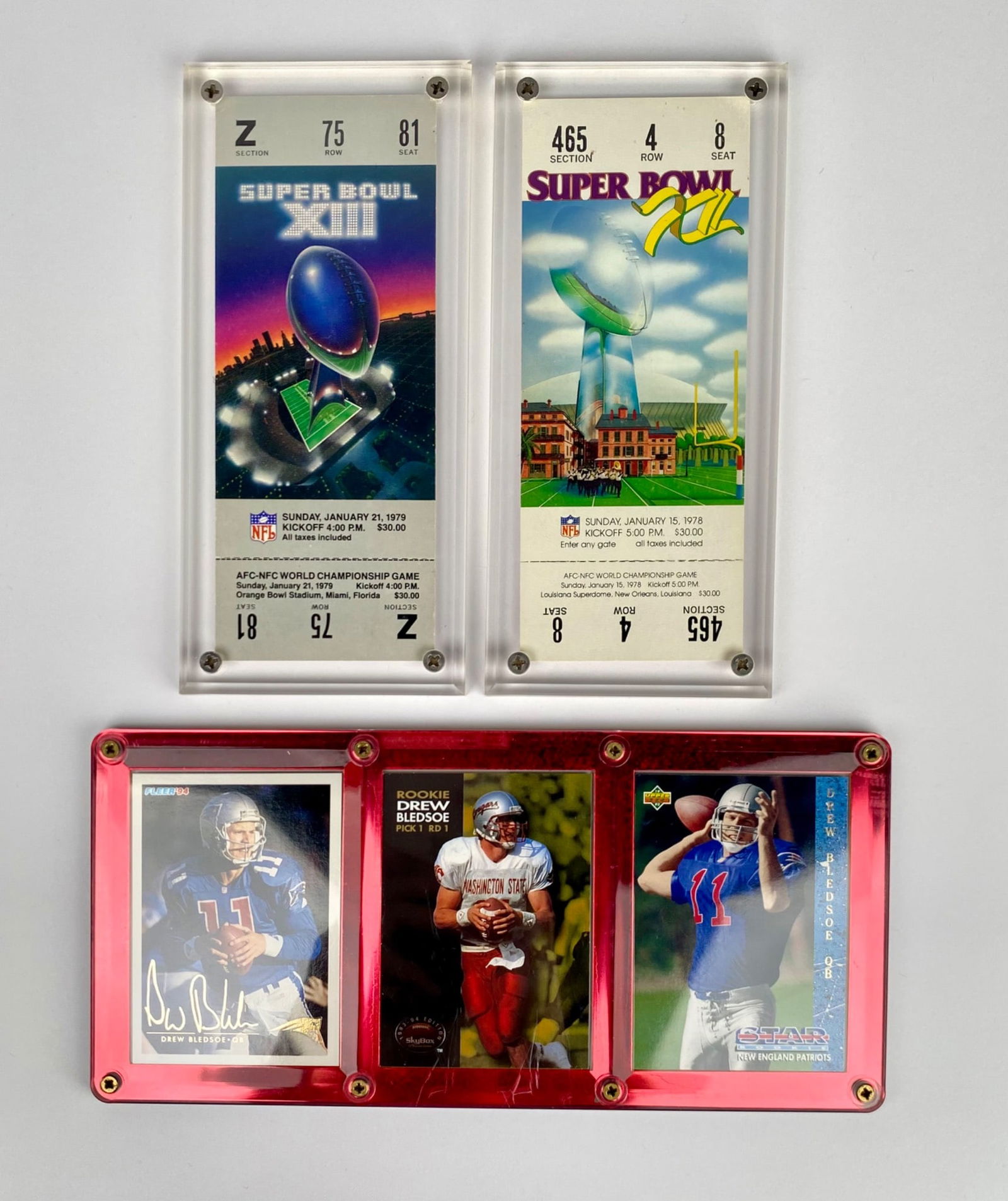 Super Bowl Tickets & Drew Bledsoe Football Cards in Display Cases: Two commemorative Super Bowl tickets and three Drew Bledsoe football cards displayed in clear and metallic border cases. Super Bowl tickets represent games from 1978 (Super Bowl XII) and 1975 (Super B