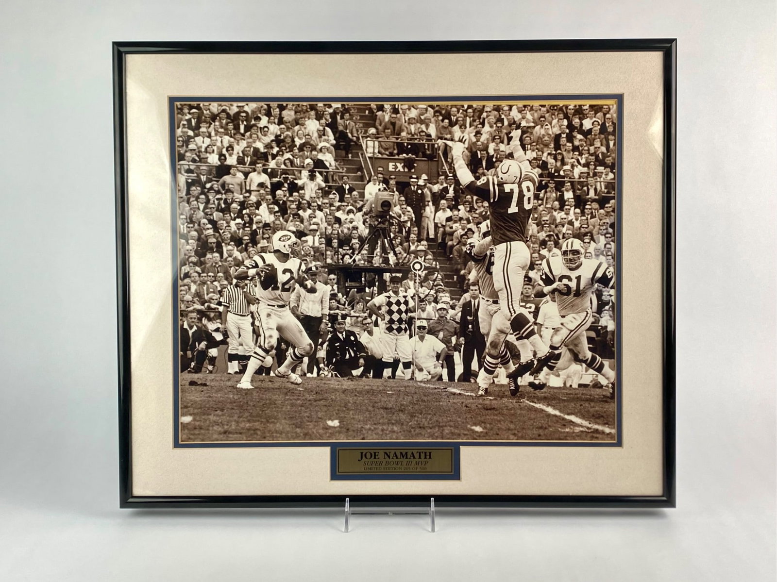 Joe Namath Limited Edition Super Bowl III Framed Photograph: Framed limited edition photograph of Joe Namath, quarterback of the New York Jets, captured in action during Super Bowl III. A brass plaque below the image reads “Joe Namath, Super Bowl III MVP, Lim