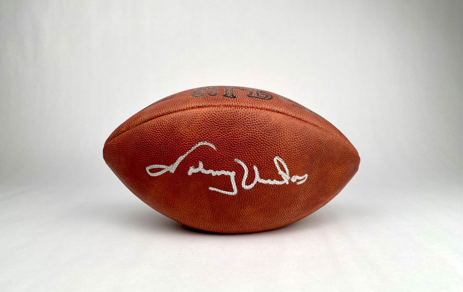 Wilson NFL Football Signed by Johnny Unitas: Wilson NFL official football signed by Johnny Unitas in silver ink. The football features NFL branding and inscriptions of ‘National Football League,’ ‘American Football Conference,’ and ‘Na