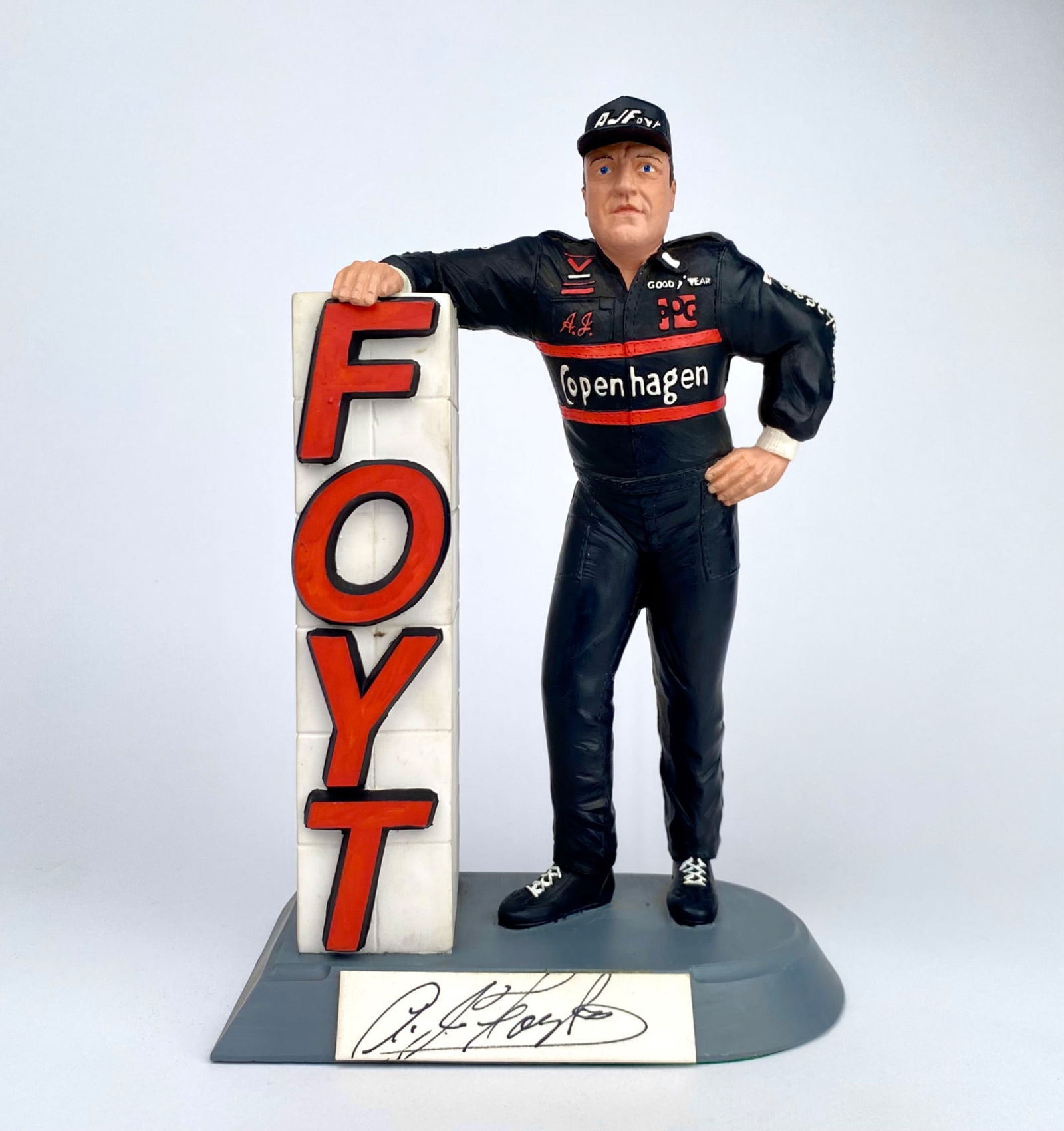 A.J. Foyt ‘The Legend’ Figurine with Autograph, 1991 (#604/1500): Salvino figurine titled ‘A.J. Foyt – The Legend,’ issued in 1991. Made of resin and mounted on a display base, the figure depicts legendary racer A.J. Foyt in a black racing uniform with ‘Cope