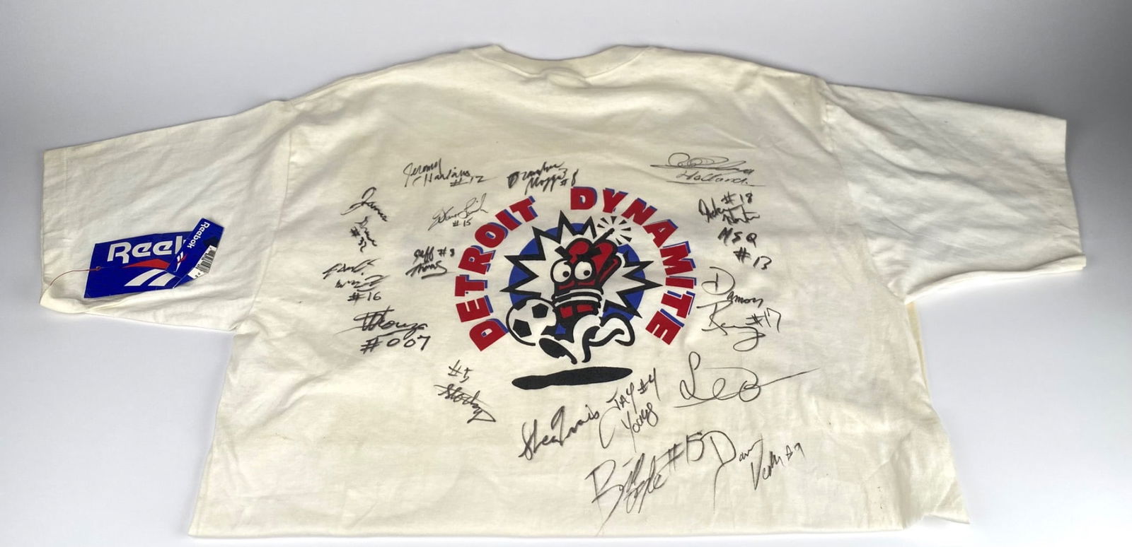 Detroit Dynamite Signed Reebok Men’s XL T-Shirt: Reebok men’s XL T-shirt featuring the Detroit Dynamite logo on the back with numerous player signatures. The front displays the Reebok logo, with original Reebok tags attached. Made in the USA. The