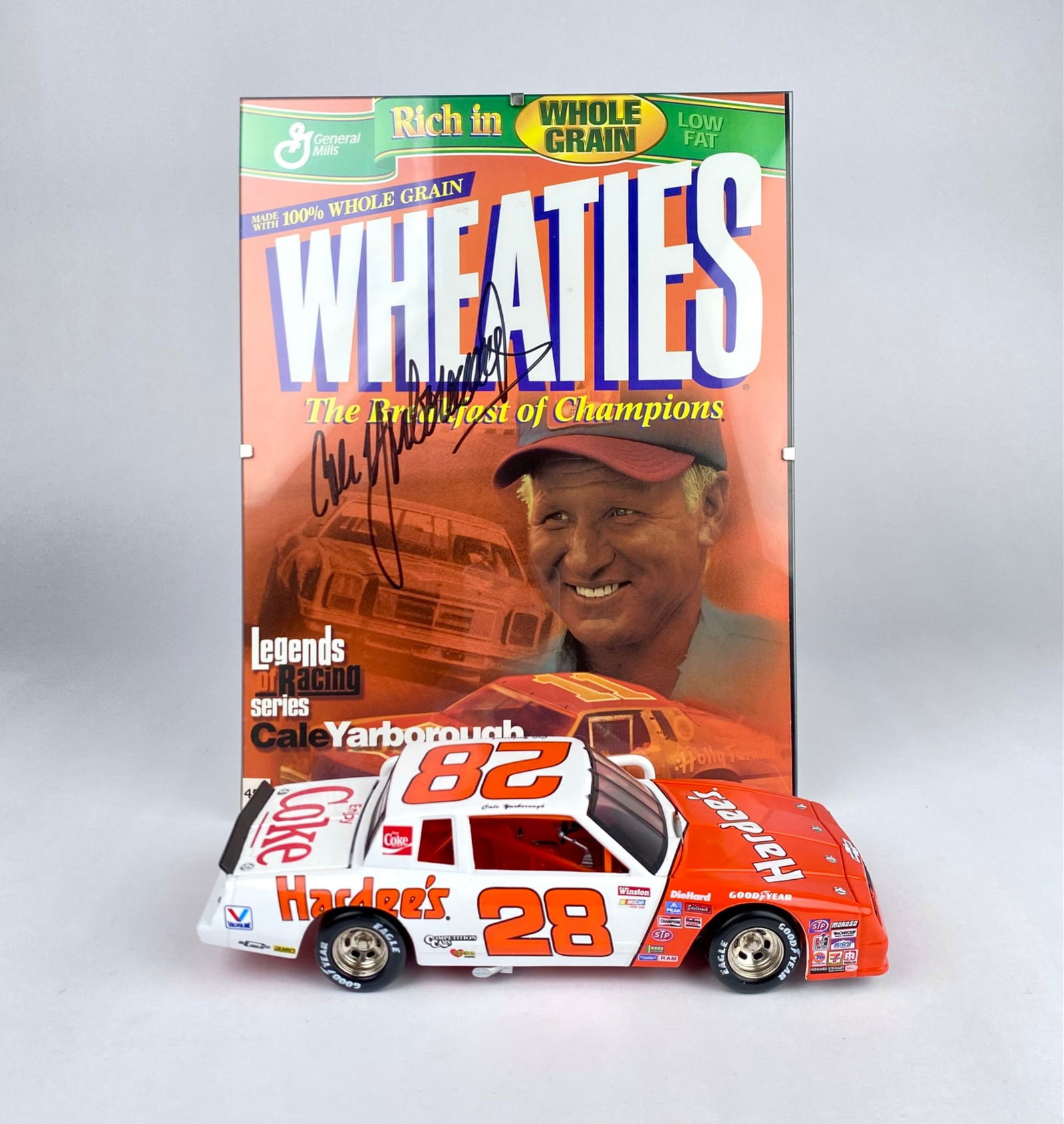 Signed Cale Yarborough Wheaties Display with No. 28 Hardee’s Diecast Car: Cale Yarborough Wheaties display featuring an autographed Wheaties box cover with Yarborough’s signature in ink. Included is a detailed 1:24 scale diecast model of Yarborough’s No. 28 Hardee’s C