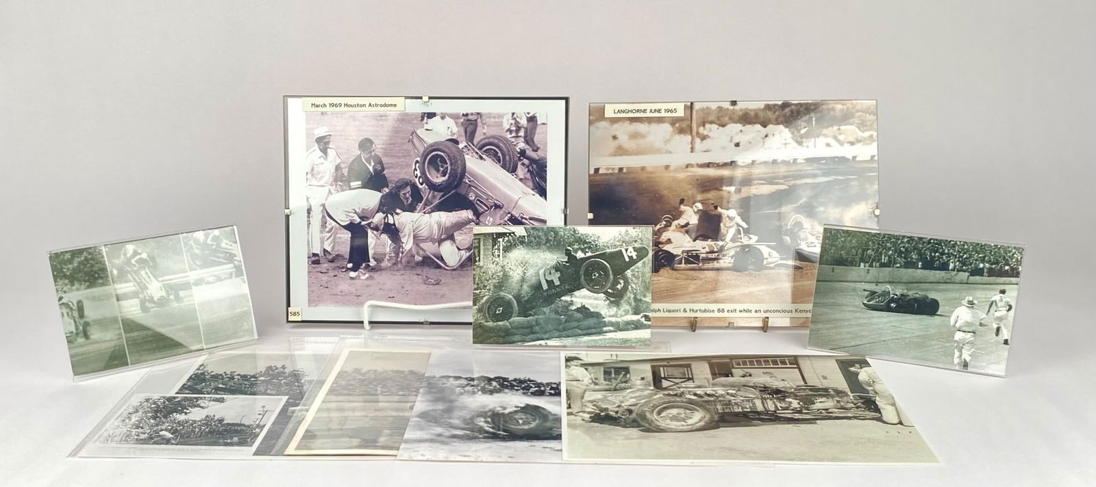 Vintage Automobile Racing Accident Photographs and Ephemera: Black-and-white photographs depicting automobile racing accidents. Highlights include images from March 1960 at Houston Astrodome and Langhorne in June 1965. Some photographs feature captions detailin
