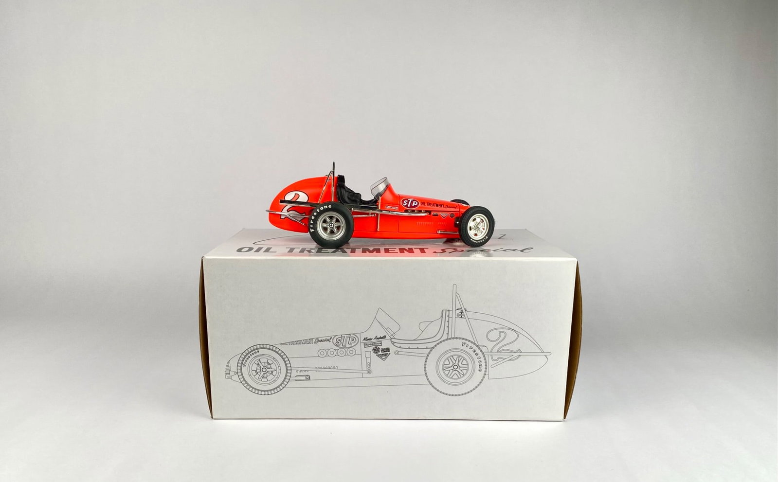 1:18 Scale Mario Andretti STP Oil Treatment Special Dirt Champ Model, The Vintage Series with: 1:18 scale model of the Mario Andretti STP Oil Treatment Special Dirt Champ car, part of The Vintage Series. This die-cast collectible is presented in a labeled box with artwork and details about the 