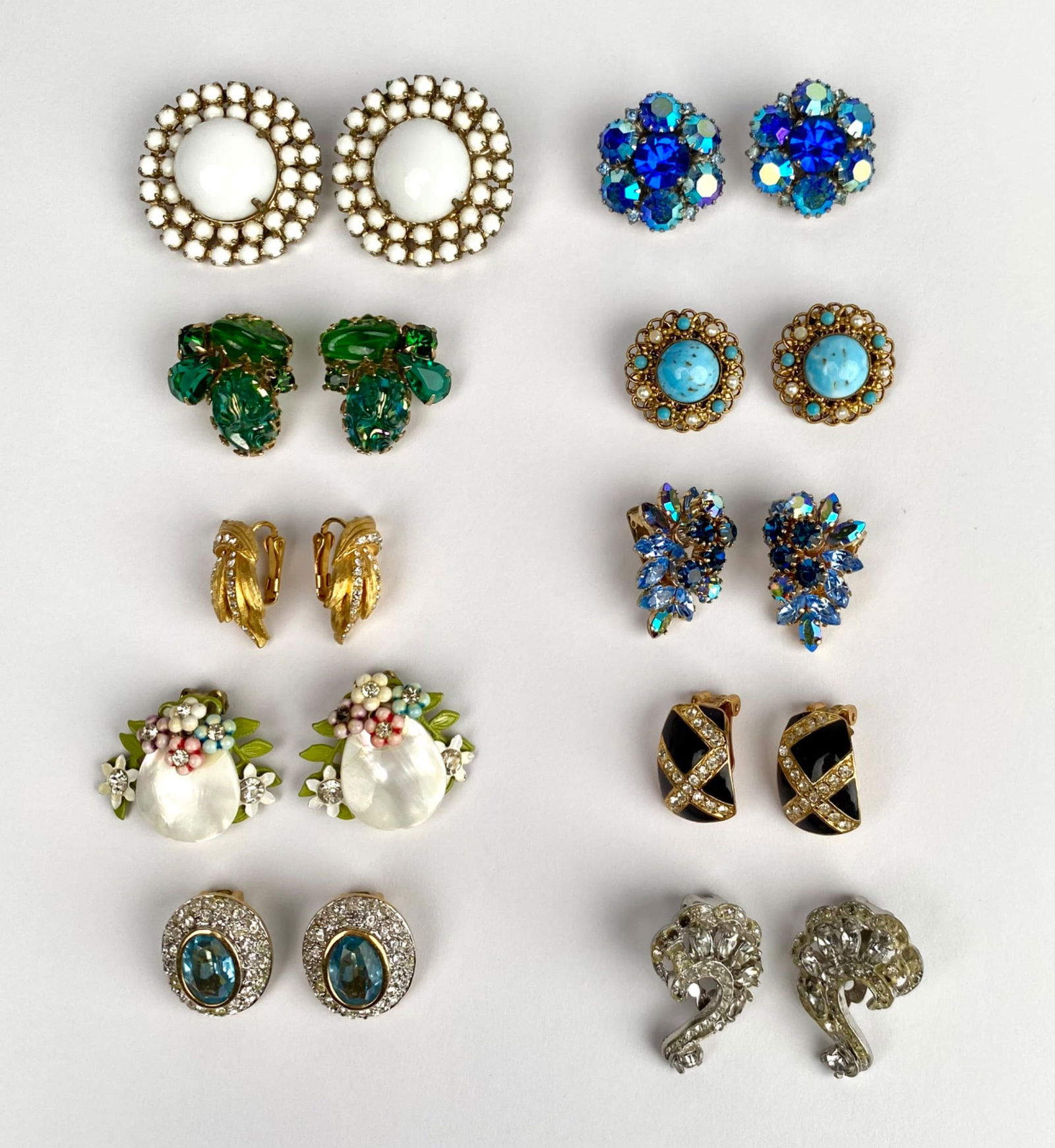 10 Pairs of Vintage Clip-On Earrings with Signed Pieces: 10 pairs of clip-on earrings featuring a variety of styles, materials, and designs, including beads, faux gemstones, enamel, and crystal. Several pairs are signed, including Warner, W. Germany, Holly