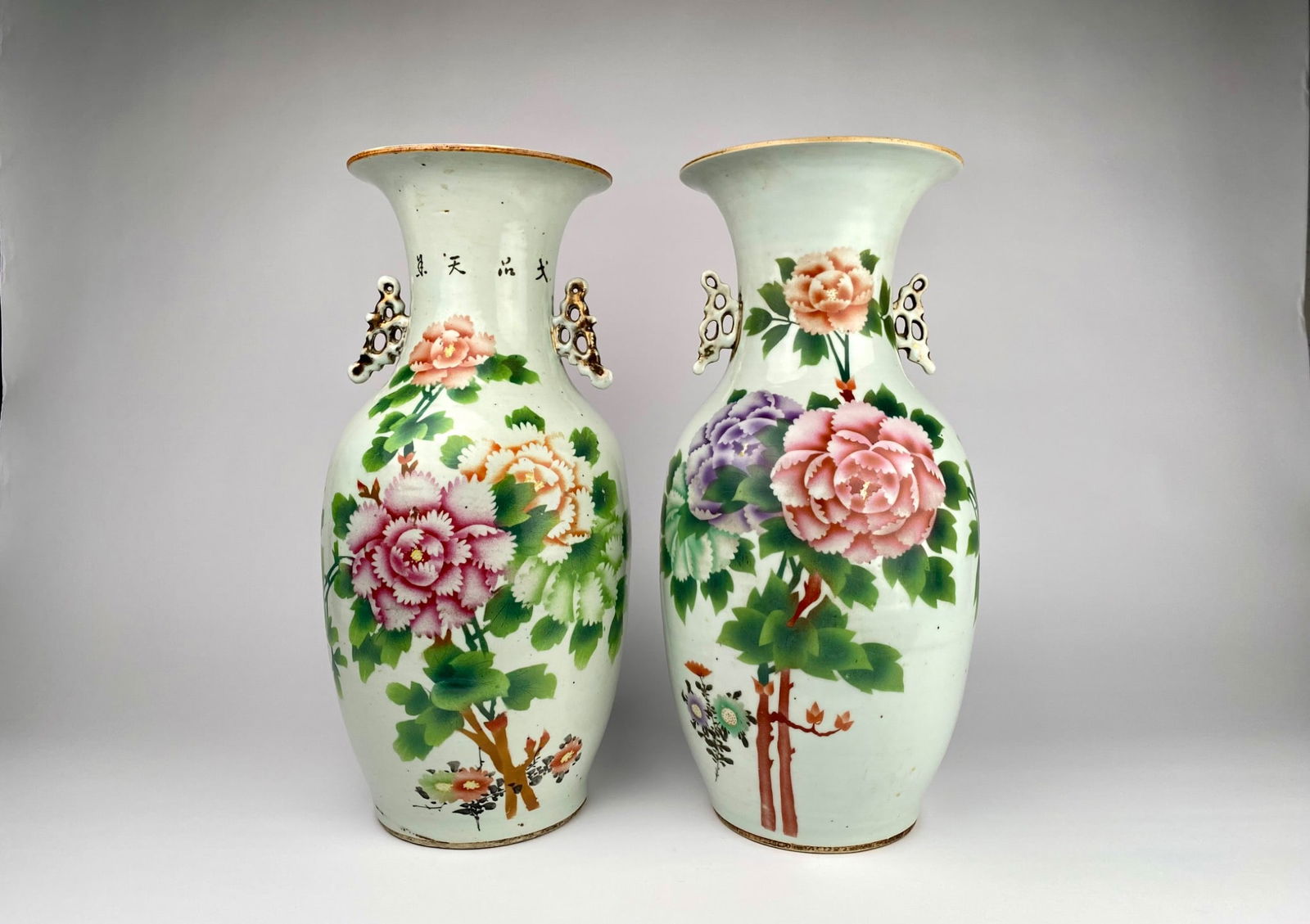Pair of Chinese Republic Famille-Rose Peony Vases, c. 1915-1940: Matched pair of hand-painted porcelain vases, Republic period (c. 1915-1940), Jinhdezhen. Baluster form with flared rims and reticulated butterfly-form gilt-highlighted handles. Famille-rose peony pan