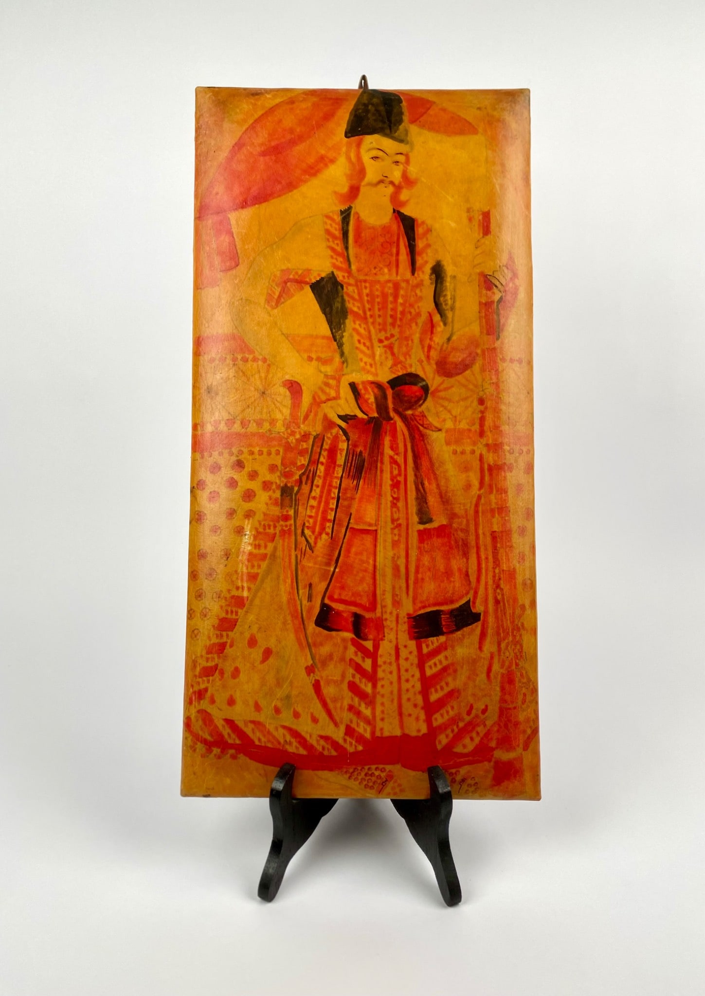 Handcrafted Leather Panel with Painted Noble Figure: Handcrafted rectangular leather panel featuring a painted depiction of a figure in traditional noble court attire. Presented in vivid hues of red, gold, and black with intricate detailing on the garme