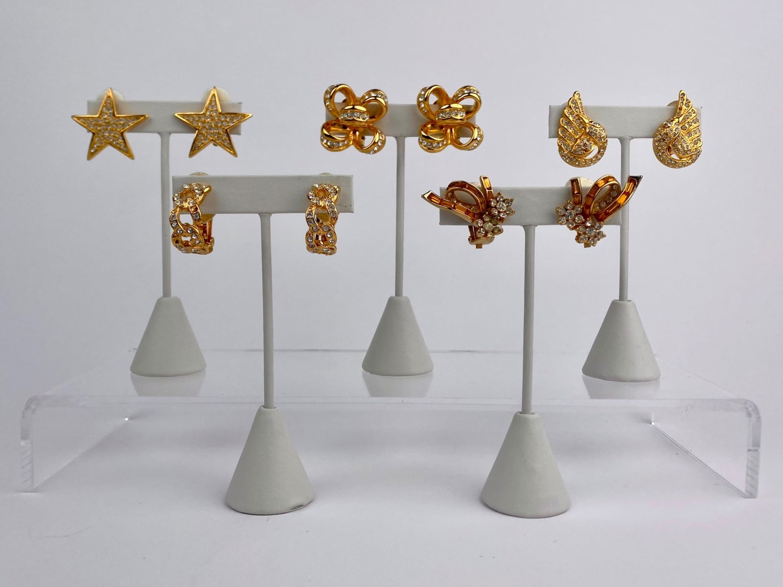 Group of Five Signed Gold-Tone Rhinestone Clip-on Earrings (Joan Rivers, Kenneth Jay Lane, ORA): Group of five pairs of vintage gold-tone rhinestones clip-on earrings by costume jewelry designers Joan Rivers, Kenneth Jay Lane, and ORA. The lot includes two pairs marked Joan Rivers, two pairs mark