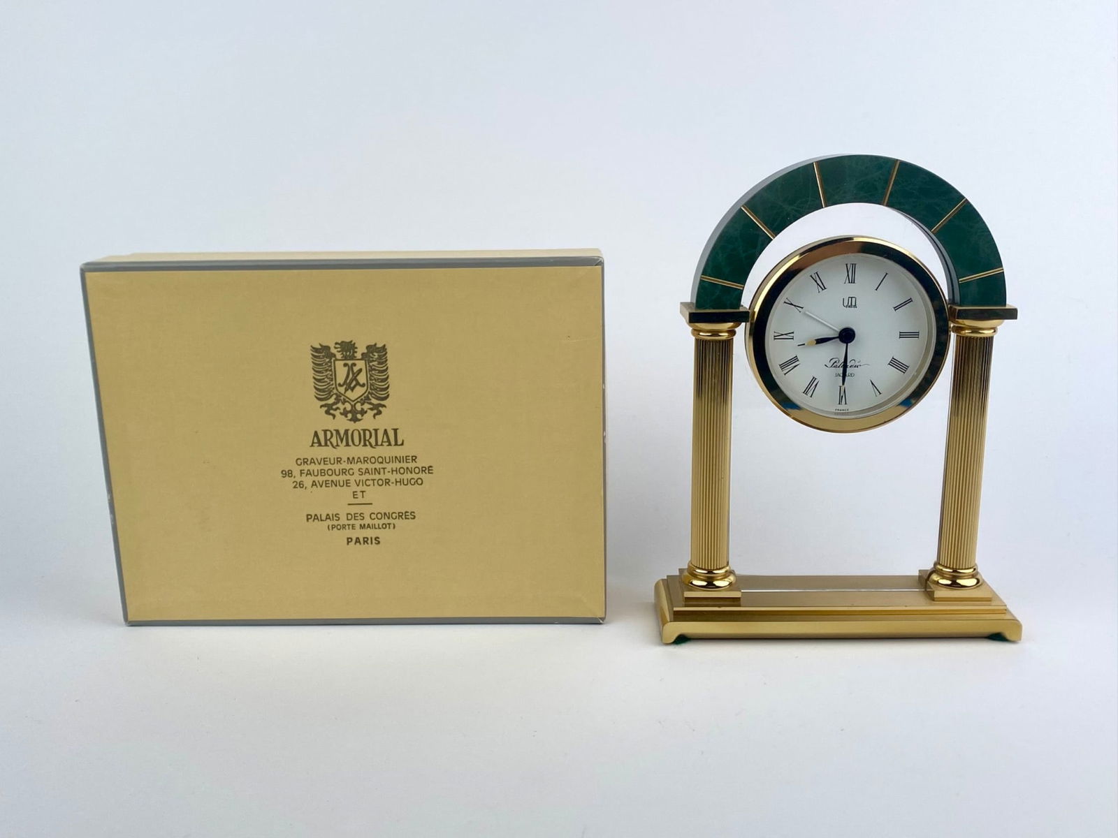 Jaeger Paris Gilt Metal and Green Marble Desk Clock with Original Box: Jaeger Paris desk clock featuring an architectural form with twin fluted gilt metal columns supporting a green marble arch. The circular dial is marked “Jaeger Paris” and “France,” wit