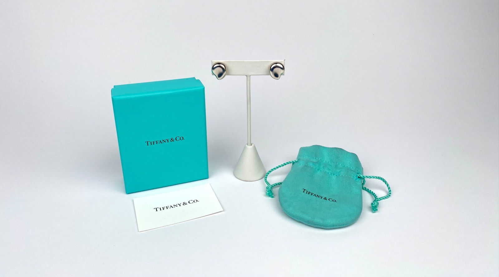 Tiffany & Co. Sterling Silver Elsa Peretti Clip Earrings with Box & Pouch: Tiffany & Co. sterling silver heart-shaped clip-on earrings designed by Elsa Peretti. Marked “Tiffany & Co. 925” on the back of each earring. Includes the original Tiffany & Co. box, protectiv