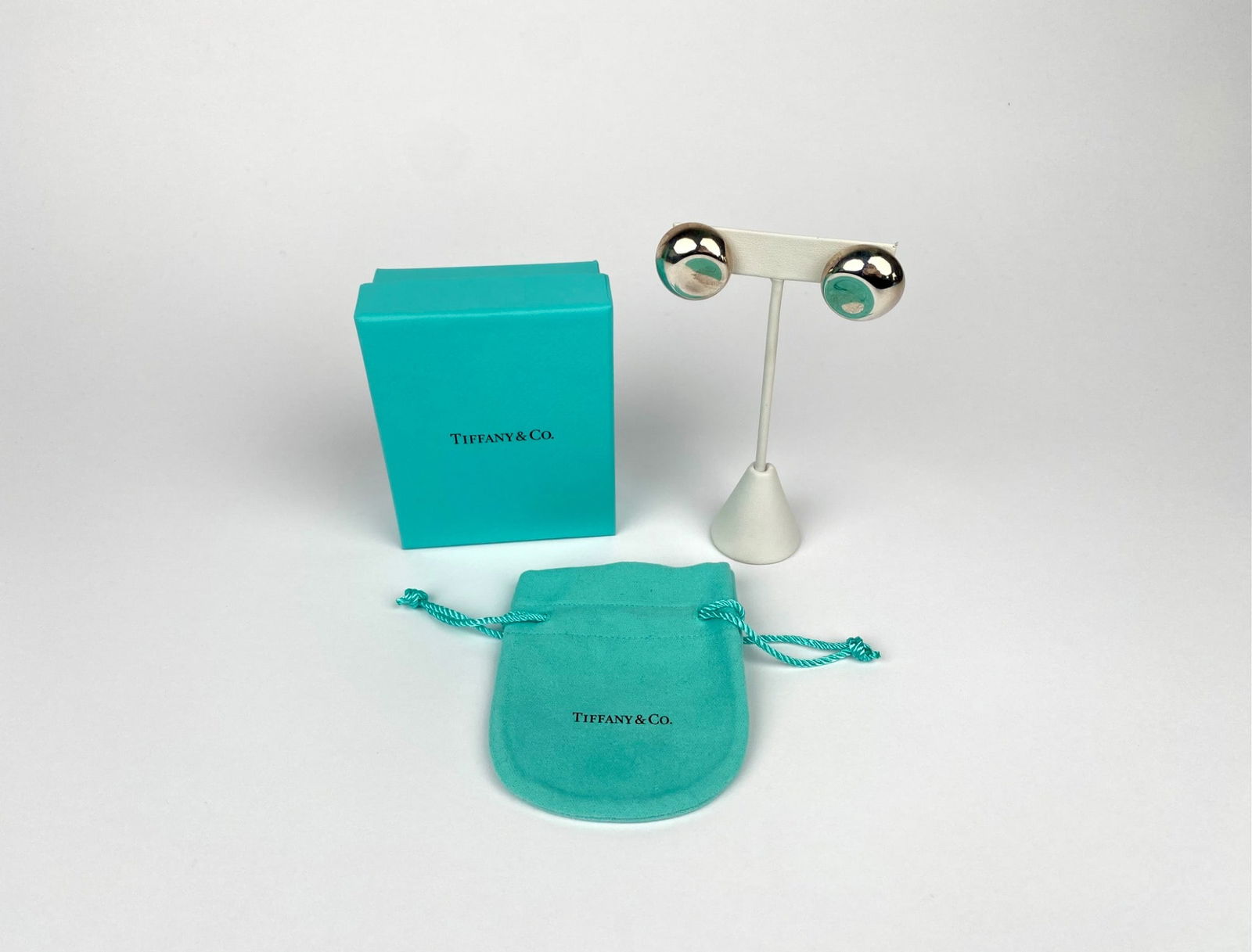 Tiffany & Co. Elsa Peretti Sterling Silver Clip Earrings with Box & Pouch: Elsa Peretti sterling silver clip-on earrings by Tiffany & Co., featuring a polished spherical design. Stamped on the back with the hallmark “Tiffany & Co. Elsa Peretti Spain 925.” Includes th