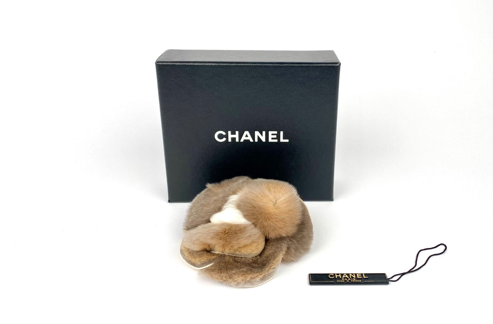 Chanel Rabbit Fur Camellia Flower Brooch with Original Box: Chanel rabbit fur camellia flower brooch. It is constructed of layered rabbit fur petals in graduated natural tones, mounted on a concealed backing with a pin closure. The brooch has its original tag