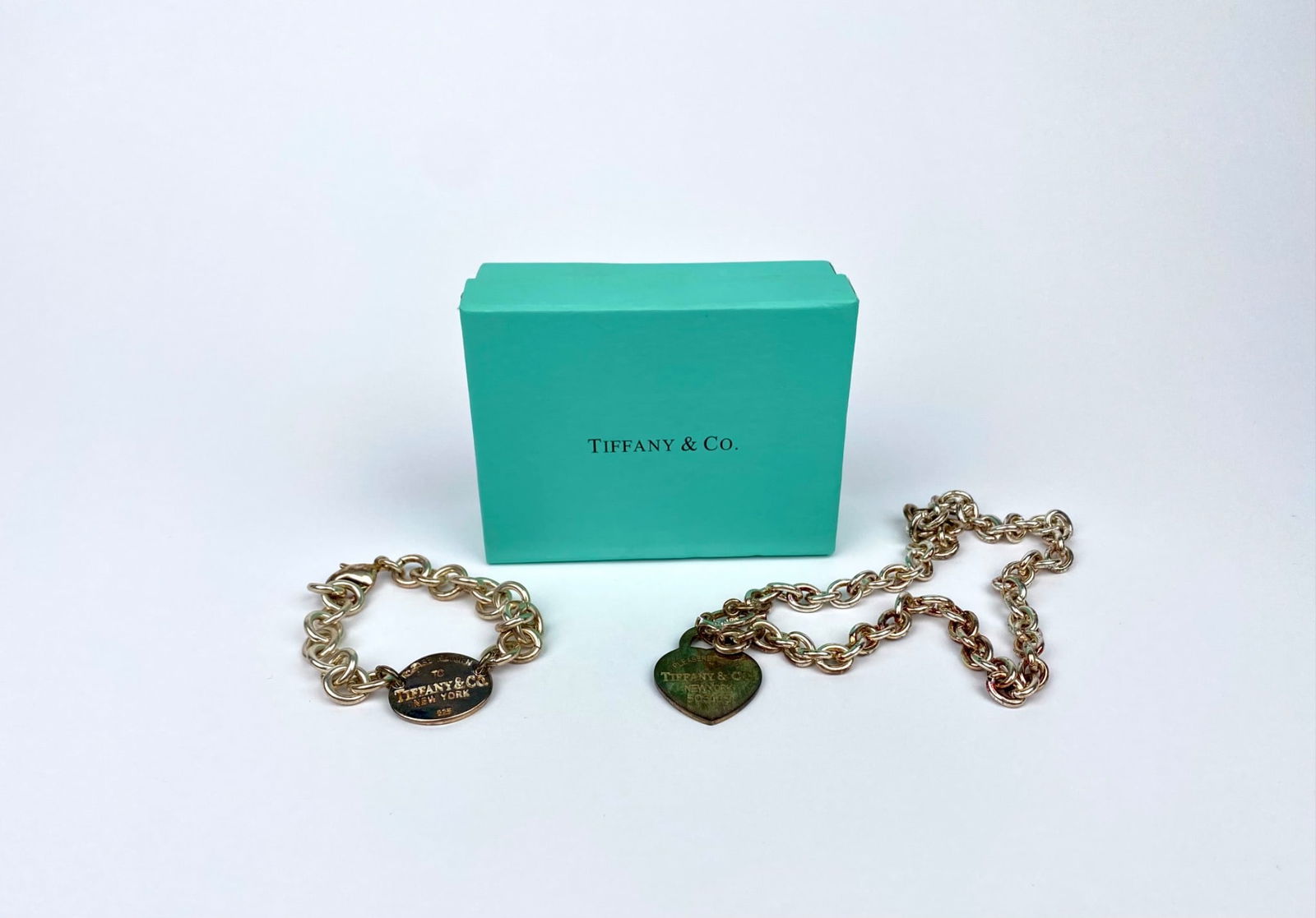 Tiffany & Co. Sterling Silver Heart Tag Necklace & Oval Tag Bracelet with Box: Tiffany & Co. sterling silver chain-style necklace and bracelet set. The necklace features a heart-shaped pendant engraved with ‘PLEASE RETURN TO TIFFANY & CO. NEW YORK 925’ and the bracelet featu