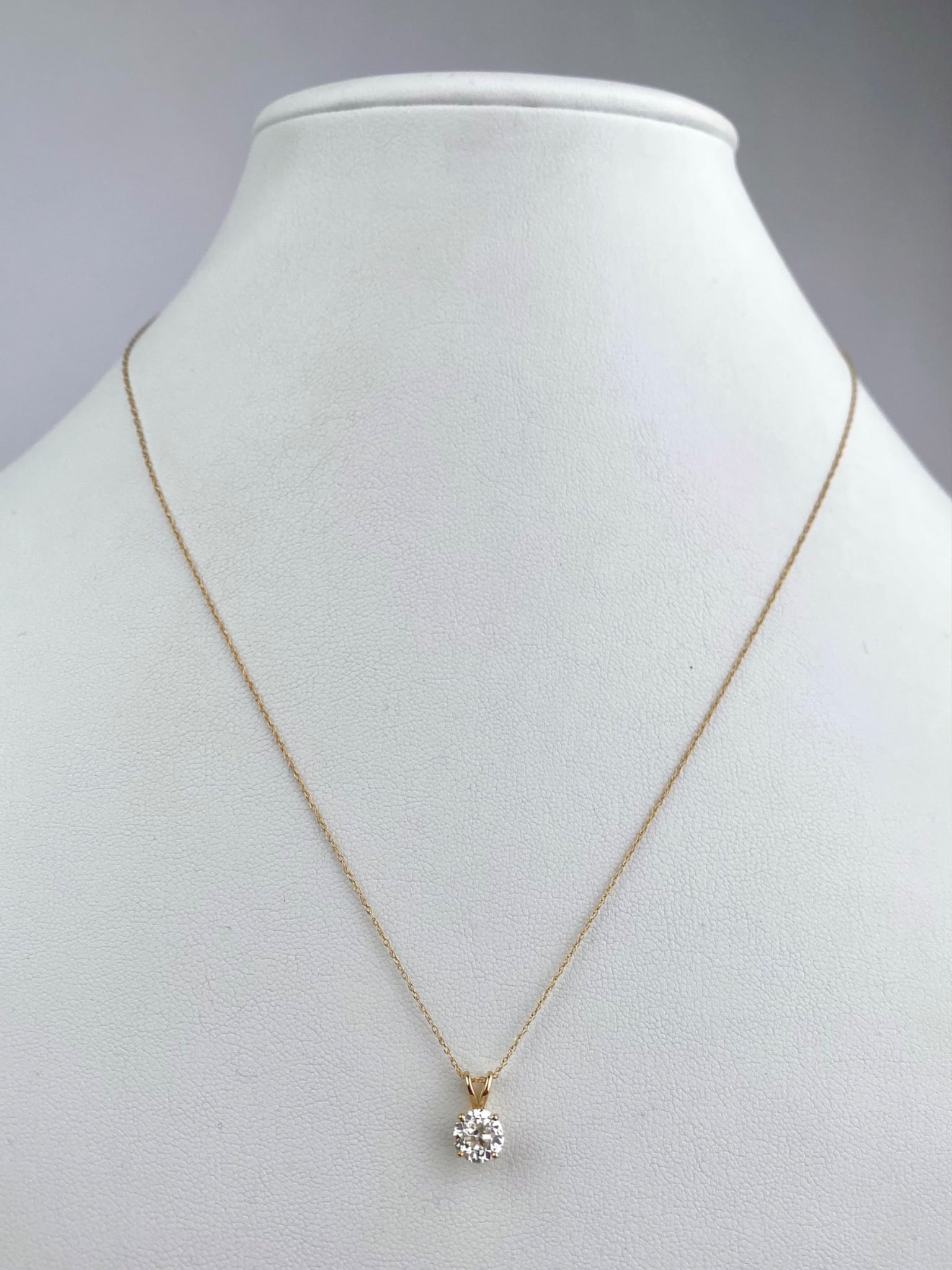 14K Yellow Gold Old European Cut Diamond Pendant Necklace: 14K yellow gold pendant necklace set with a single Old European cut diamond weighing approximately 1.21 carats. The diamond is graded H color with SI-2 clarity. The diamond is mounted in a classic fou