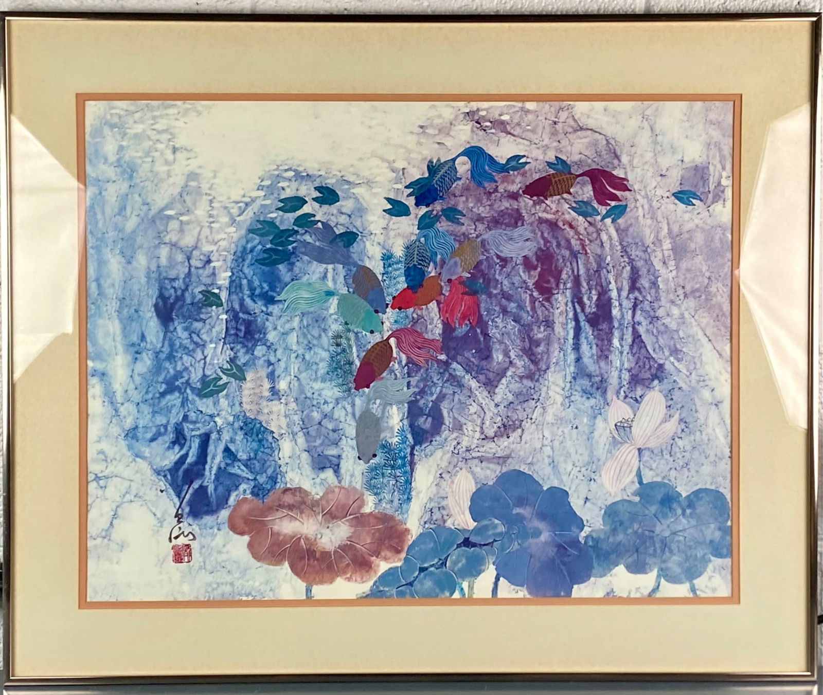 Framed Chinese School Koi and Lotus Mixed Media Painting: Framed Chinese school mixed media painting depicting a colorful grouping of koi fish swimming among lotus leaves against a layered blue and violet background. A brush signature with a red seal appears