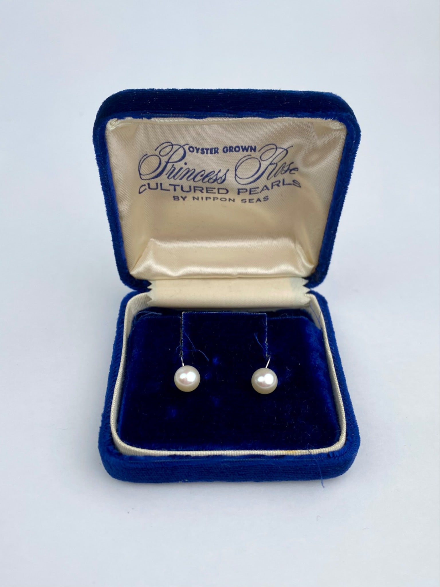 Princess Rose Cultured Pearl 14K Screw-Back Earrings: Pair of Princess Rose oyster-grown cultured pearl earrings mounted in 14K white gold screw-back settings. The earrings are presented in their original “Princess Rose – Cultured Pearls by Nippon Se