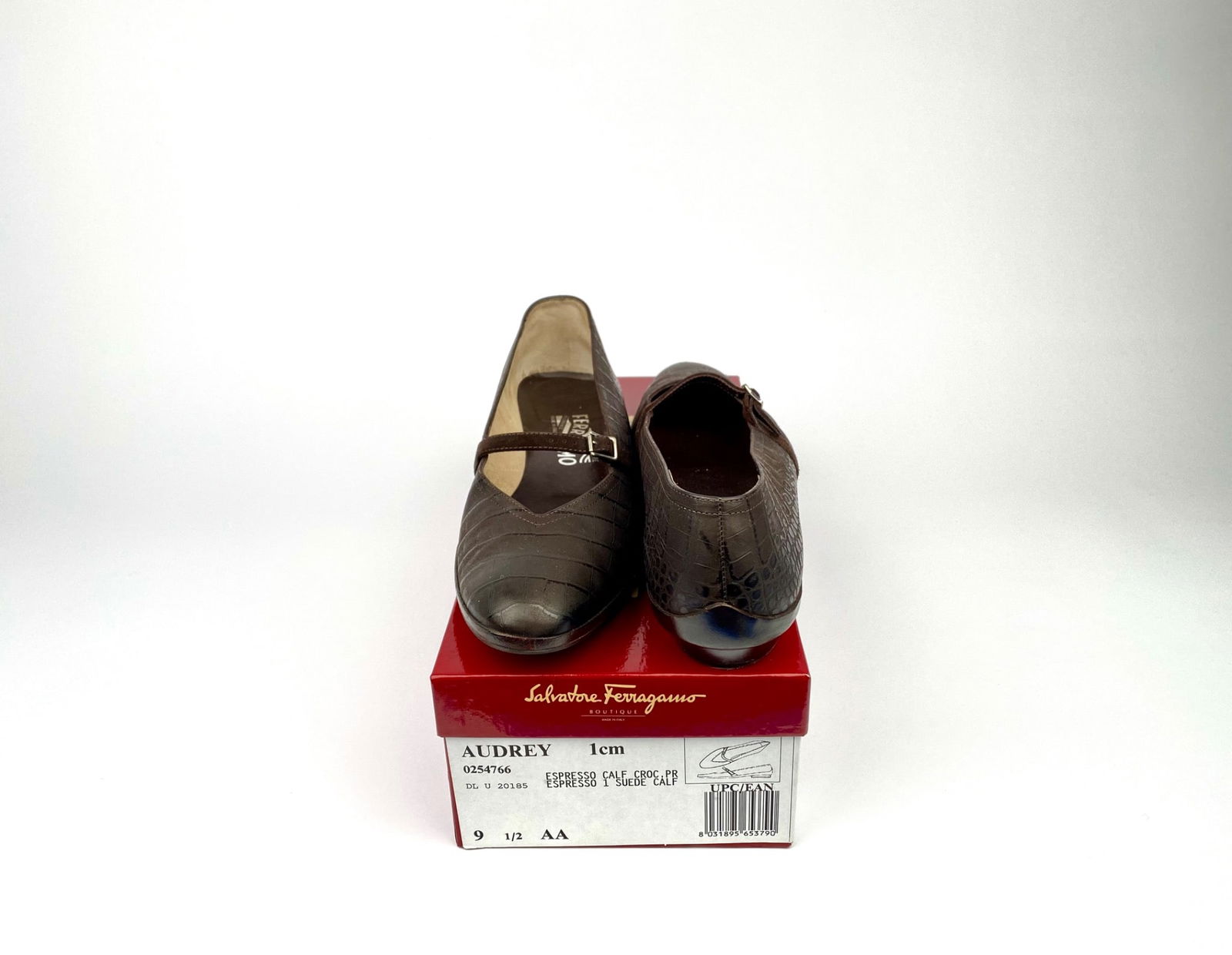 Salvatore Ferragamo ‘Audrey’ Brown Crocodile Embossed Leather Flats, Size 9.5 AA with Box: Women’s Salvatore Ferragamo flats crafted in brown embossed leather, featuring a crocodile pattern and adorned with a suede buckle strap. These shoes are labeled as made in Italy and come in size 9.