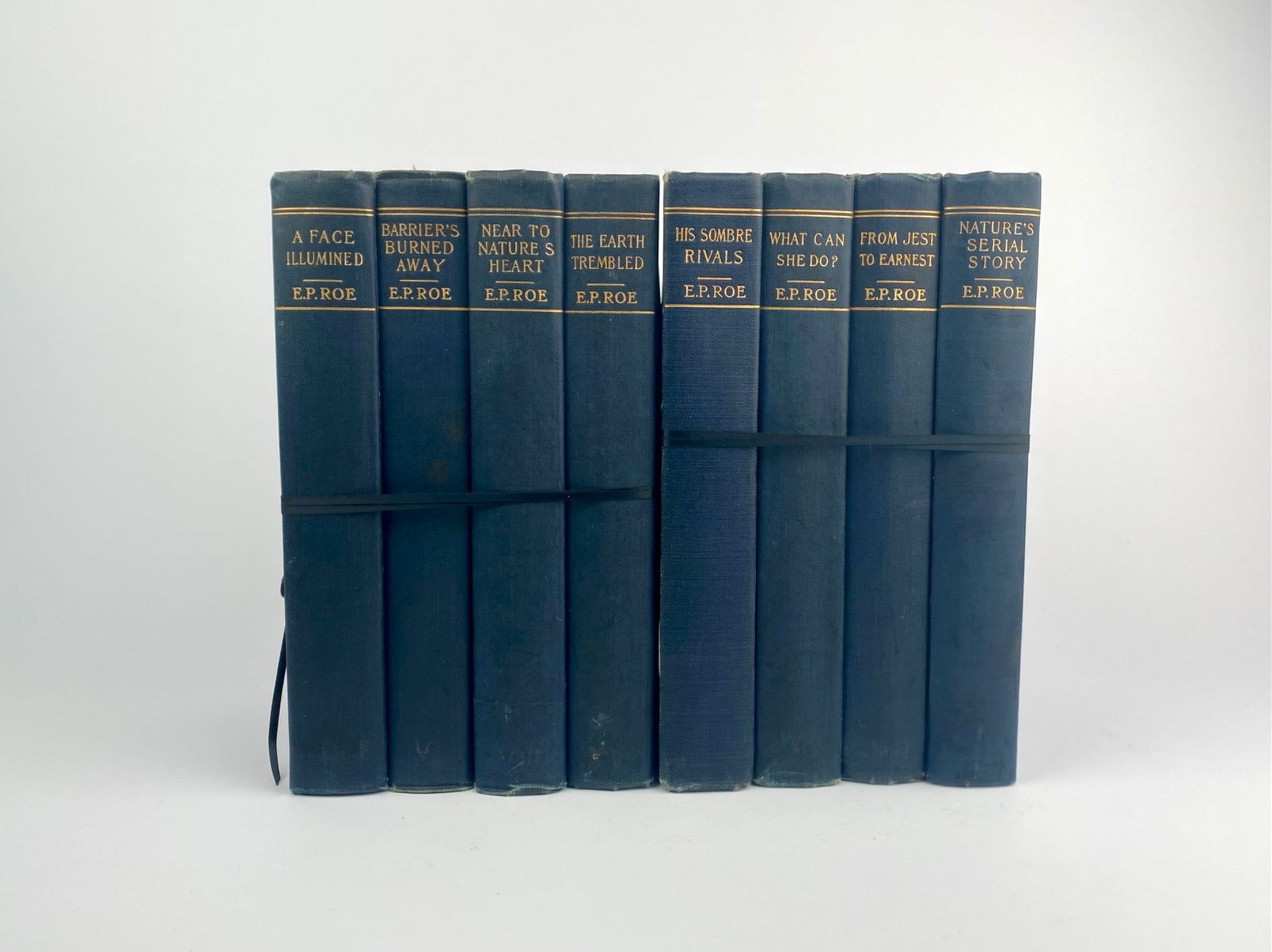 E.P. Roe Decorative Blue Cloth Novel Set, 8 Volumes: Coordinated set of eight hardcover novels by E.P. Roe, uniformly bound in blue cloth with gilt spine titles. Titles in the set includes “A Face Illumined,” “Barriers Burned Away,” “N