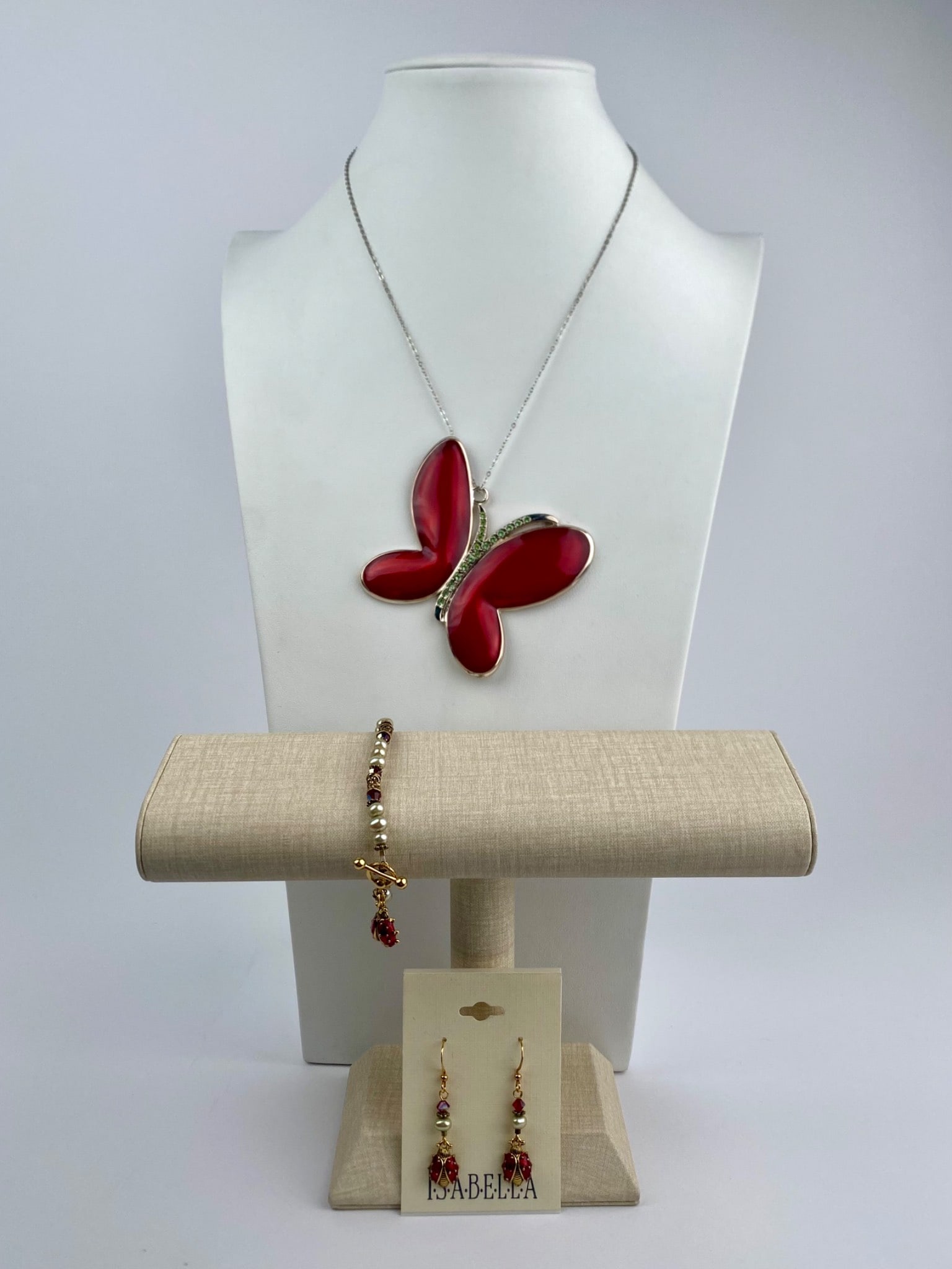 Harvey Lewis Butterfly Necklace with Isabella Earrings and Bracelet Set: Coordinated jewelry set featuring a statement butterfly pendant necklace by Harvey Lewis, paired with matching Isabella-brand earrings and bracelet. The necklace centers on a large sculptural butterfl