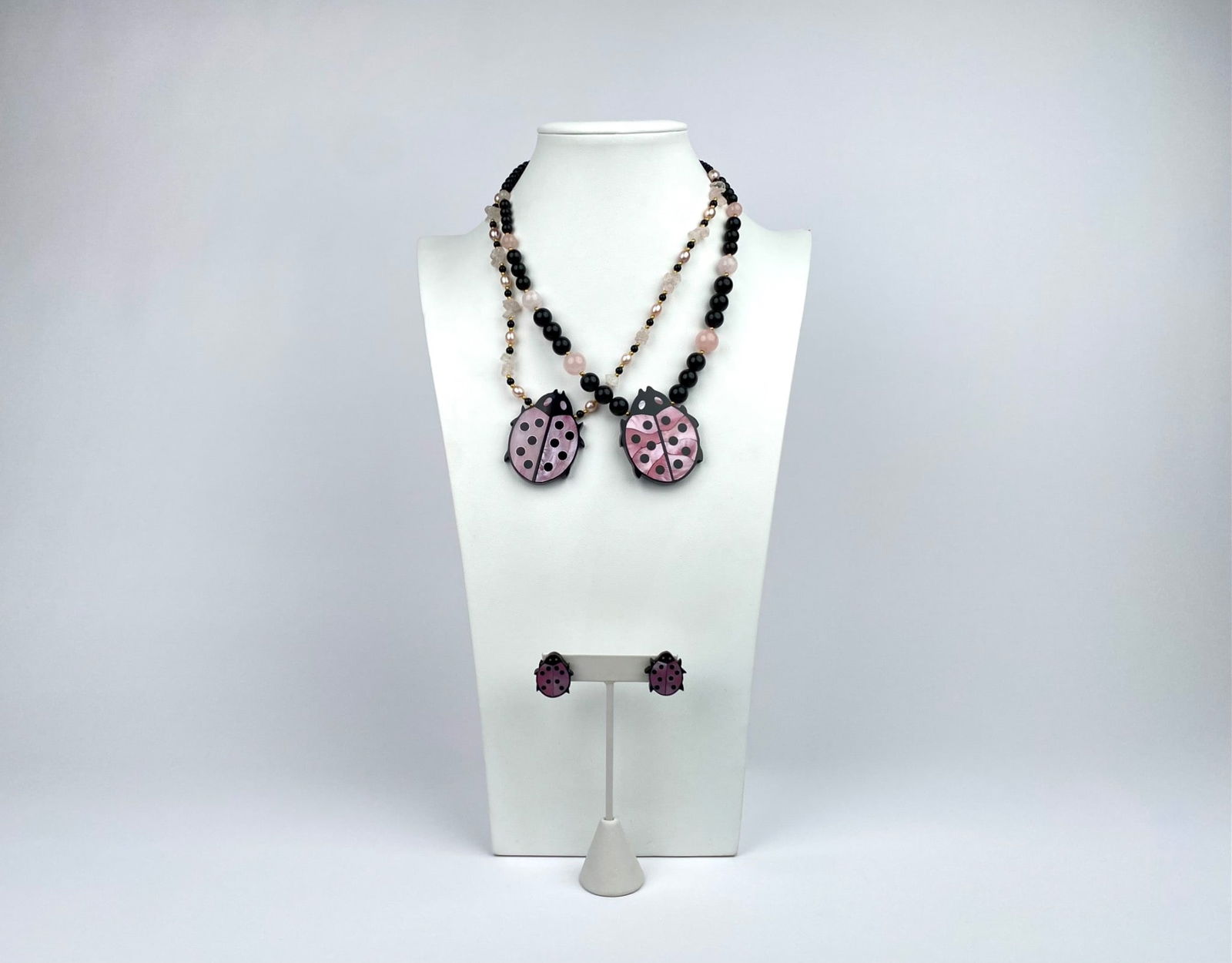 Lee Sands Ladybug Pendant Necklace & Earrings Set: Lee Sands necklaces and matching earrings featuring ladybug-shaped pendants made of resin with pink and black enamel finishes. Includes two necklaces with beadwork comprising rose quartz, pearls, blac