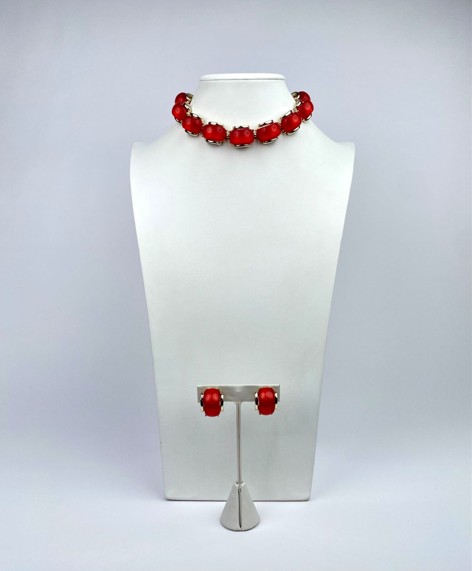Coro Gold-Tone Necklace & Earring Set with Red Resin Beads: A gold-tone jewelry set featuring a necklace and matching clip-on earrings, each adorned with red resin beads. The necklace is secured by a gold-tone clasp with an adjustable chain extender. The clip-