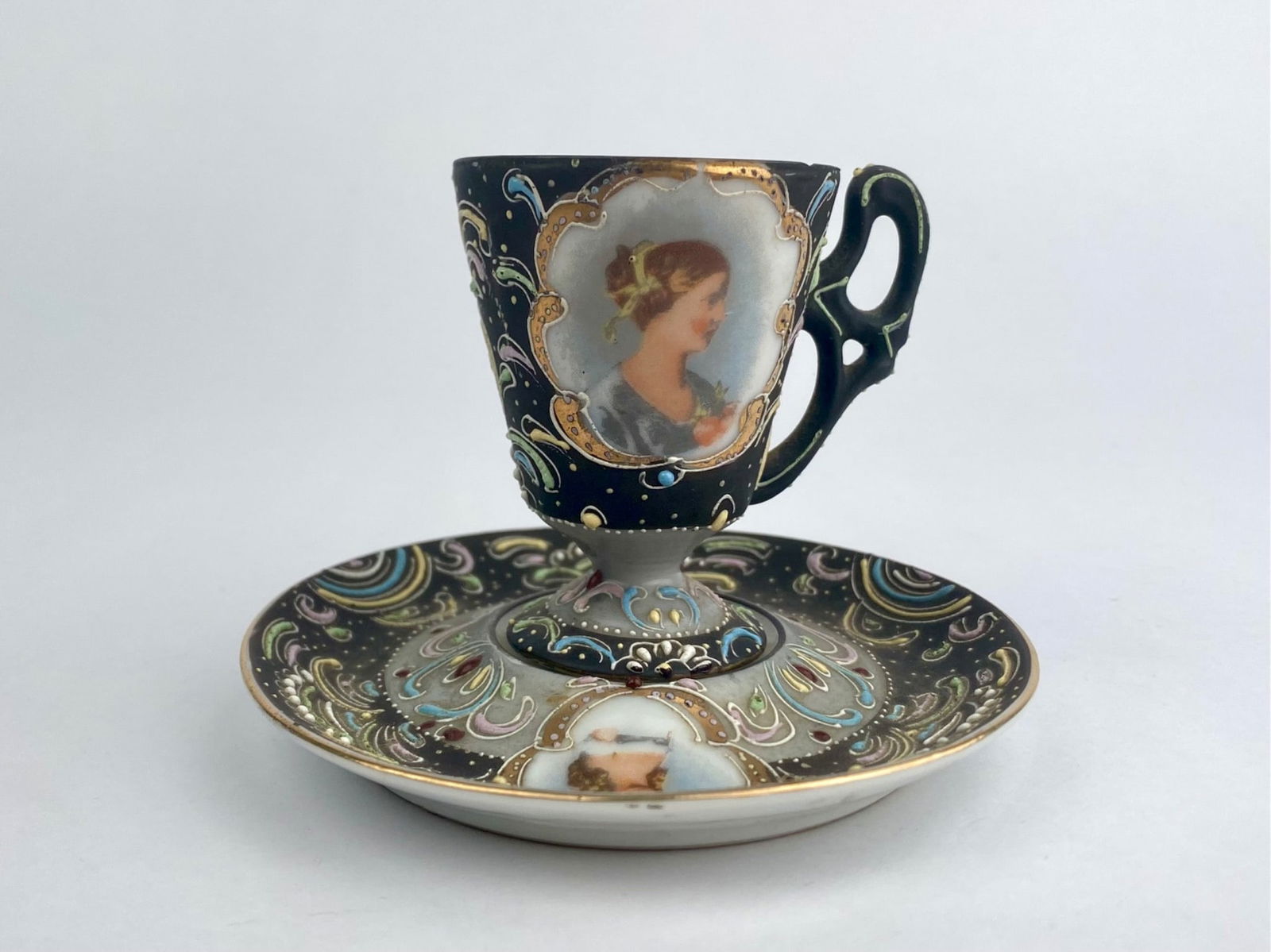 Ardalt Lenwile China Hand-Painted Demitasse Cup and Saucer, Japan: Hand-painted porcelain demitasse cup and saucer by Ardalt / Lenwile China, Japan, featuring an ornate design with raised enamel decoration, gilt accents, and jeweled detailing. The exterior displays a