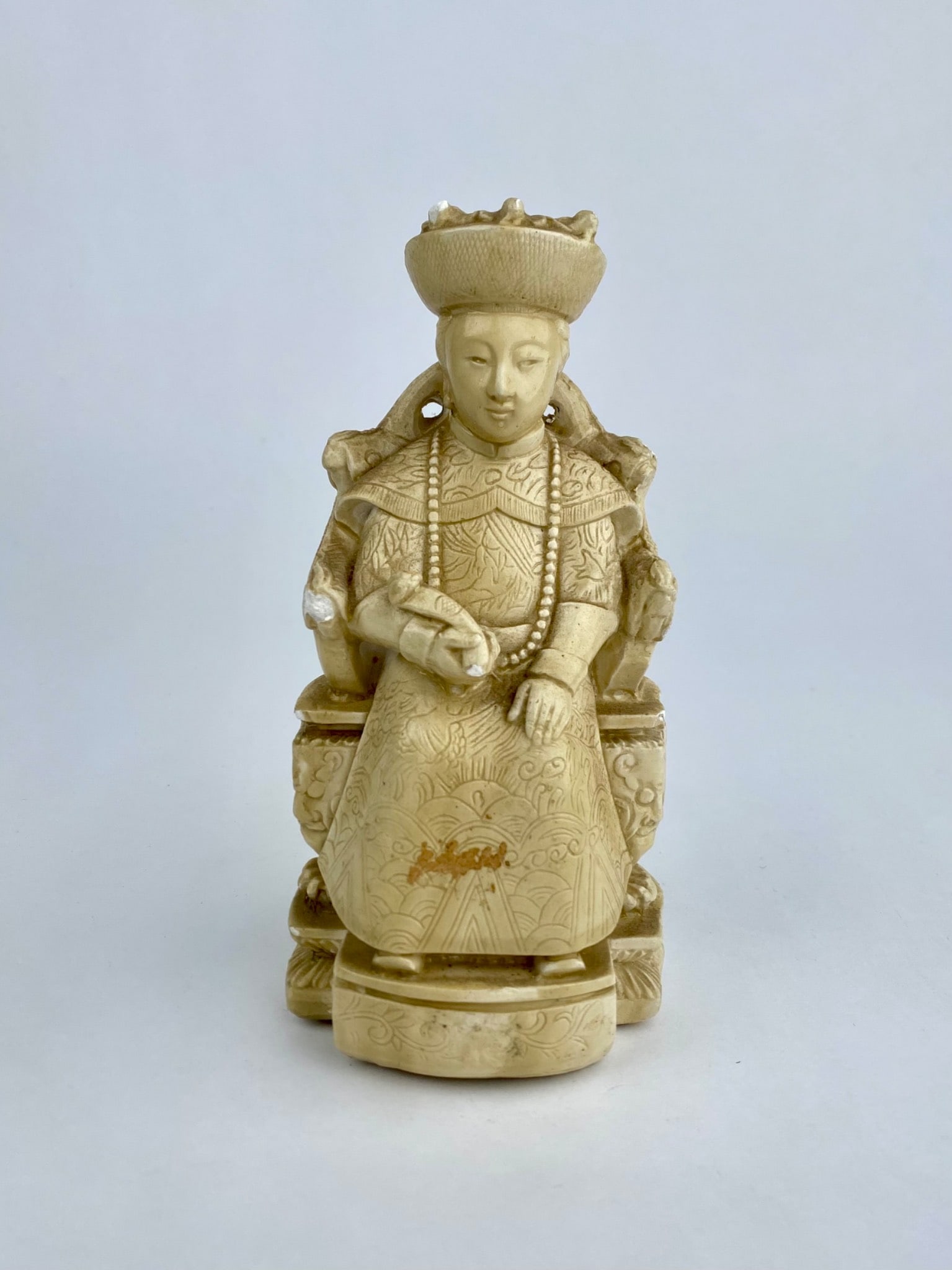 Vintage Italian Faux Ivory Asian Empress Figure: Vintage Italian made figural sculpture depicting an Asian inspired seated noblewoman or empress holding a scroll and adorned in detailed robes with incised decoration. The figure is cast in a composit