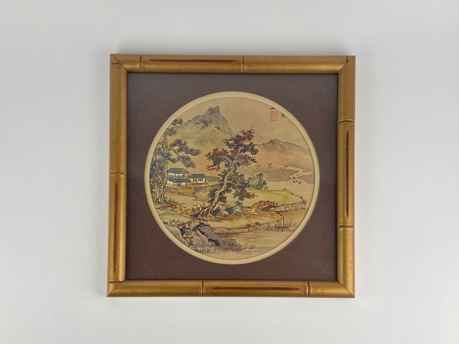 Edward Art Products ‘Oriental Landscape’ Decorative Circular Print: Decorative Orientalist landscape print produced by Edward Art Products, Chicago, Illinois. The scene depicts a mountainous landscape with traditional buildings, pine trees, a winding river, and a smal