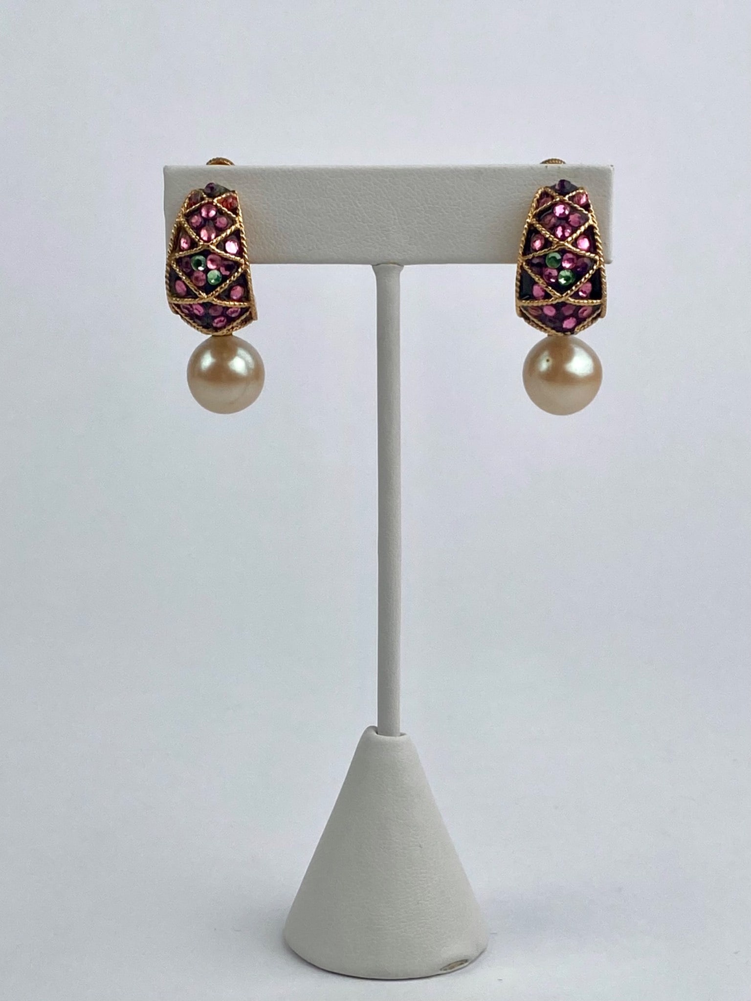 Vendome Gold-Tone Rhinestone Clip Earrings with Faux Pearl Drops: Pair of vintage Vendome clip-on earrings featuring gold-tone crescent-form settings accented with pink and green rhinestones arranged in a lattice design, each suspending a round faux pearl drop. The