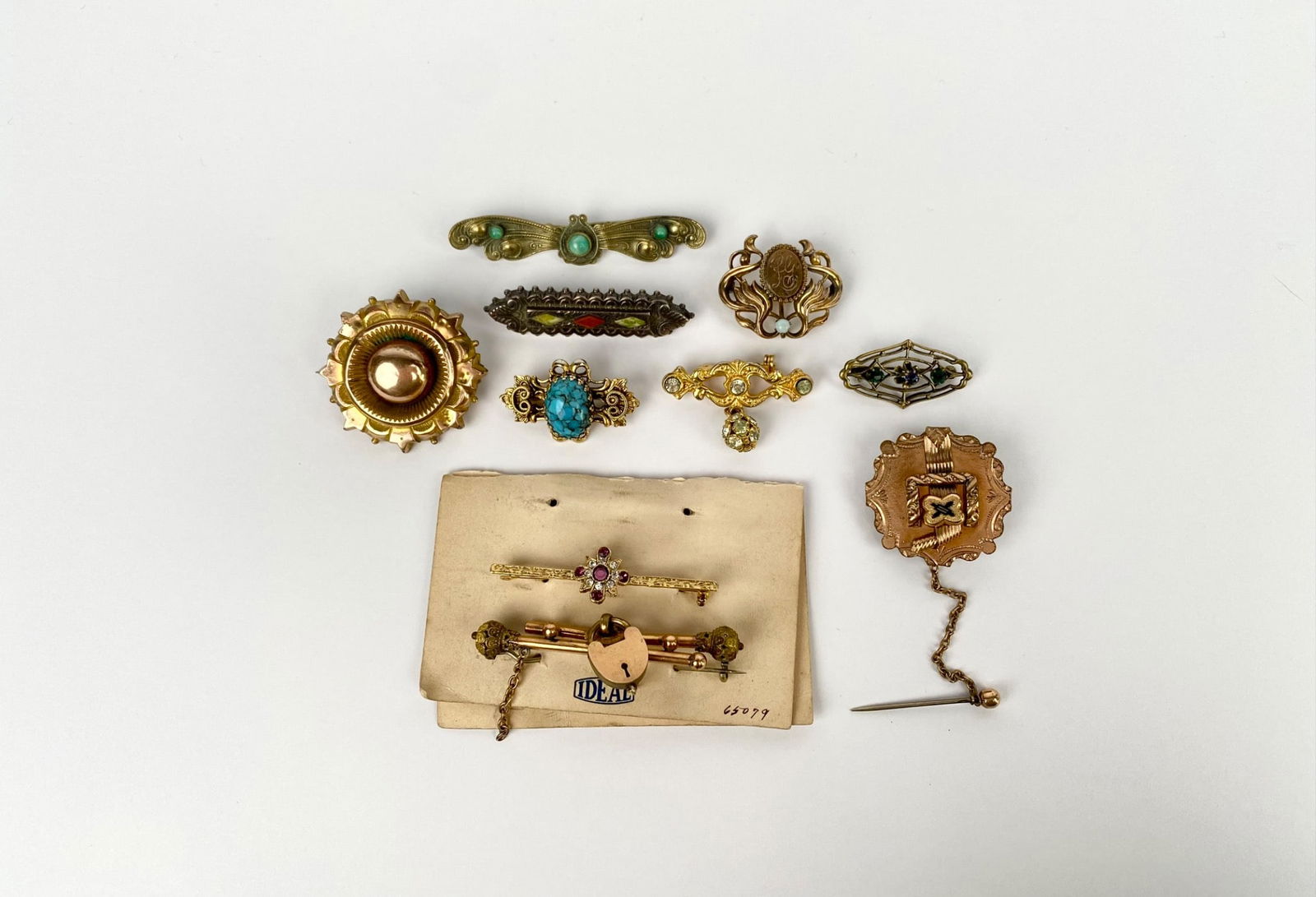Ten assorted vintage brooches featuring various designs and materials, including intricate metalwork (1 of 7)
