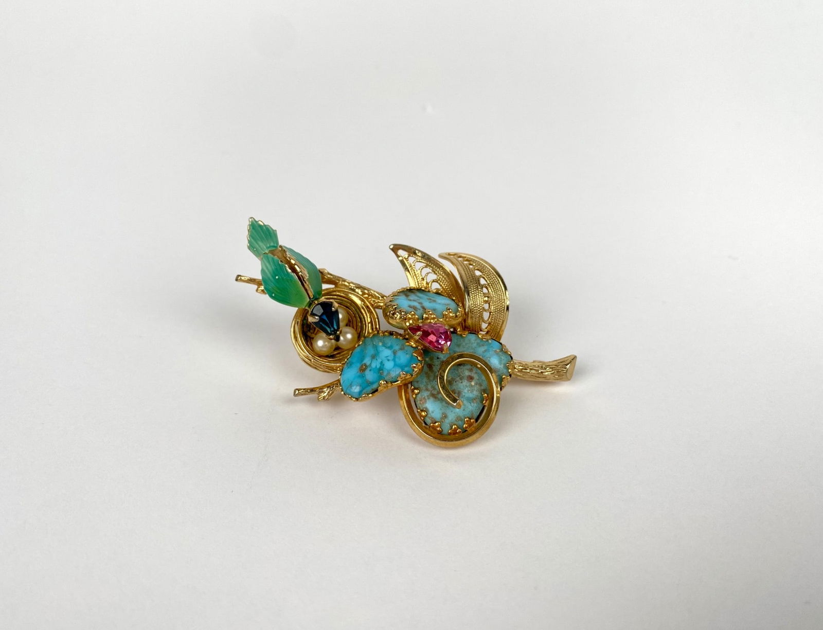 Gold-tone brooch by Jewels by Julio featuring a bird at a nest. Embellished with turquoise-colored (1 of 6)